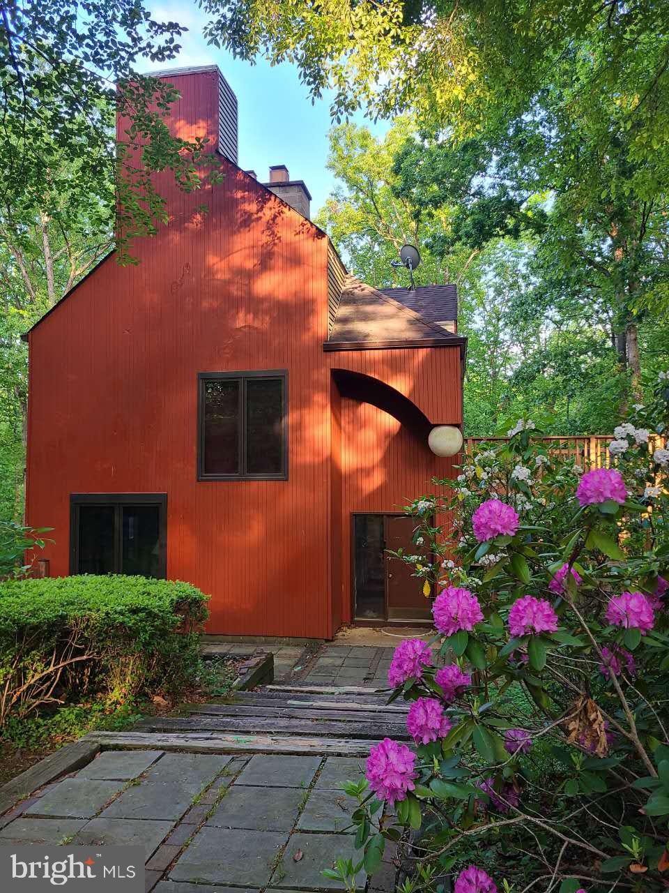 A rare opportunity to own architect Walter Roberts' iconic award-winning Sundance home in Reston. This contemporary house received the National Passive Solar Homes Award from the Department of Housing and Urban Development (HUD) in 1979 and the Award of Excellence by the Middle Atlantic Region of The American Institute of Architects (AIA) in 1983. The architect and his family lived here as the first owners. This house seamlessly blends nature, design, and modern comfort. This distinctive passive solar residence offers over 3,000 square feet of thoughtfully designed living space where expansive windows and skylights connect inside to the outdoors, while beautiful wood beams and ceilings add warmth and character. A gently descending pathway leads from the detached two-car garage to the front entrance, revealing a tranquil woodland oasis rarely found in such a convenient location. Inside, the hardwood and tile floors flow throughout three finished levels, while walls of glass capture beautiful, wooded views in every season. The stunning great room addition features dramatic vaulted ceilings and access to a wraparound deck overlooking the woodland—an ideal space for entertaining, celebrations, or simply enjoying the serenity of the natural surroundings. The primary suite offers its own fireplace, a dedicated 2nd water heater, a newly upgraded bathroom with a modern touch, and private
 access to a large, 2nd deck where you may enjoy your morning coffee, afternoon tea or just unwind at day’s end. The originally designed greenhouse on the top level has been renovated with new roofs and skylights facing south. The detached garage is complemented by a large room above, providing exceptional flexibility as a home office, studio, gym, workshop, or additional storage. Extensively updated with double-glazed Pella windows, 5 sliding doors, Mitsubishi multi-zone heating and cooling systems, renovated bathrooms, newer skylights, and numerous recent appliance upgrades. All updates were made with the original architectural style intact while allowing future owners to add their own personal touch. Ideally situated in one of Reston's most convenient locations, this home is just a short walk from Sunrise Valley Elementary, the W&OD Trail, and access to premier shopping and dining, with Route 267 only two traffic lights away for an easy commute. A home like no other, this distinctive residence offers the perfect blend of privacy, natural beauty, and convenience while still feeling worlds away from the hustle and bustle. The current owners have taken great pride in this one-of-a-kind home and hope its future owners will make it a cherished dream home of their own.