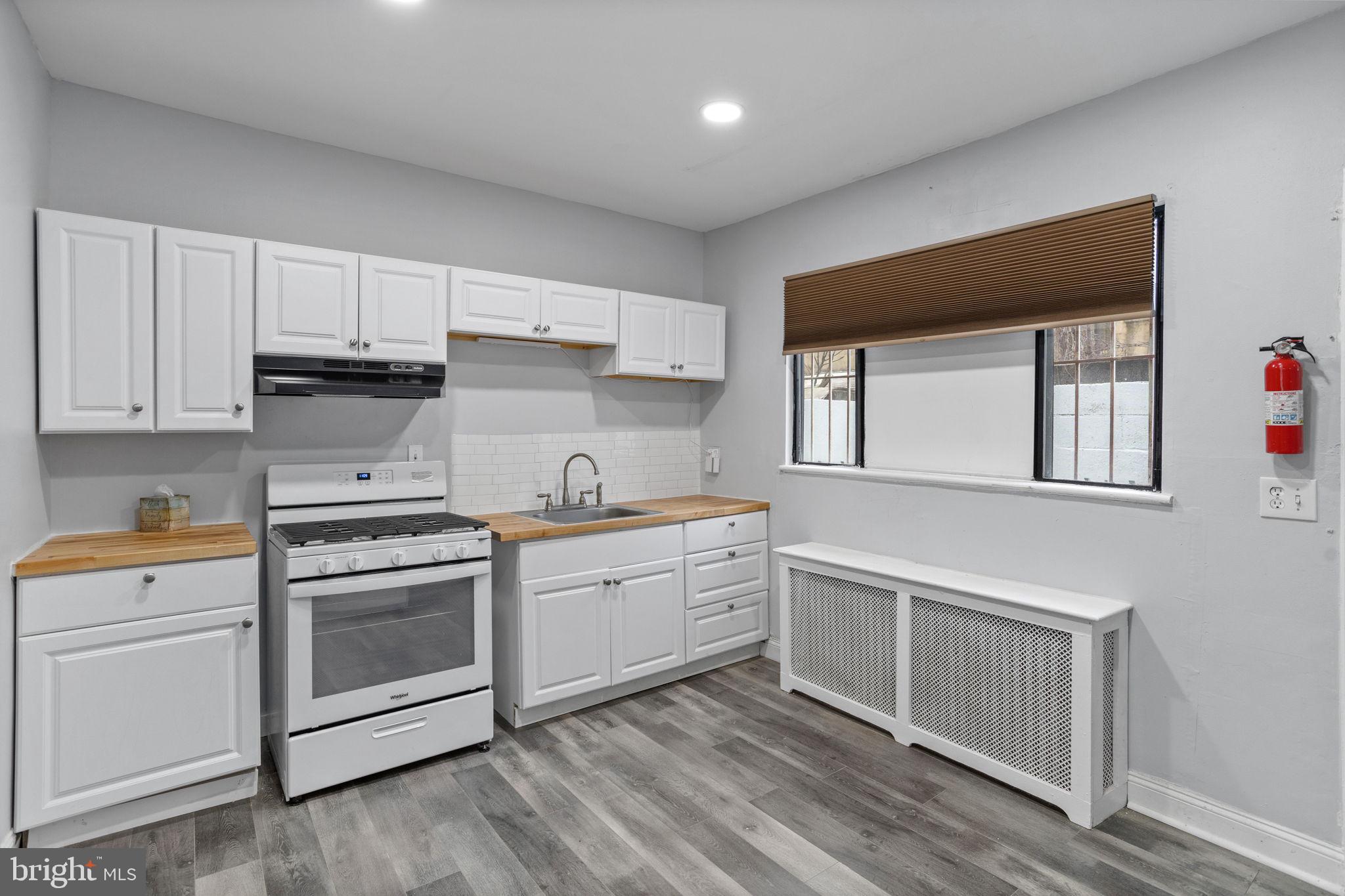 Welcome home to your oasis in East Passyunk Crossing! Come inside to your open living space with brand new floors that continue throughout the home. The kitchen awaits, with a brand new gas range stove, large refrigerator, butcher block countertops, recessed lighting, and ample storage. Beyond the kitchen lies a cozy private backyard, perfect for relaxing or entertaining. Head upstairs to find your primary and secondary bedrooms, both with built-in closets. The updated full bathroom features a shower bath and vanity. The basement offers even more space, with an in-unit washer and dryer and plenty of room for storage. Located in the heart of South Philadelphia, your new home is surrounded by all you need, including shops, restaurants, and transportation.