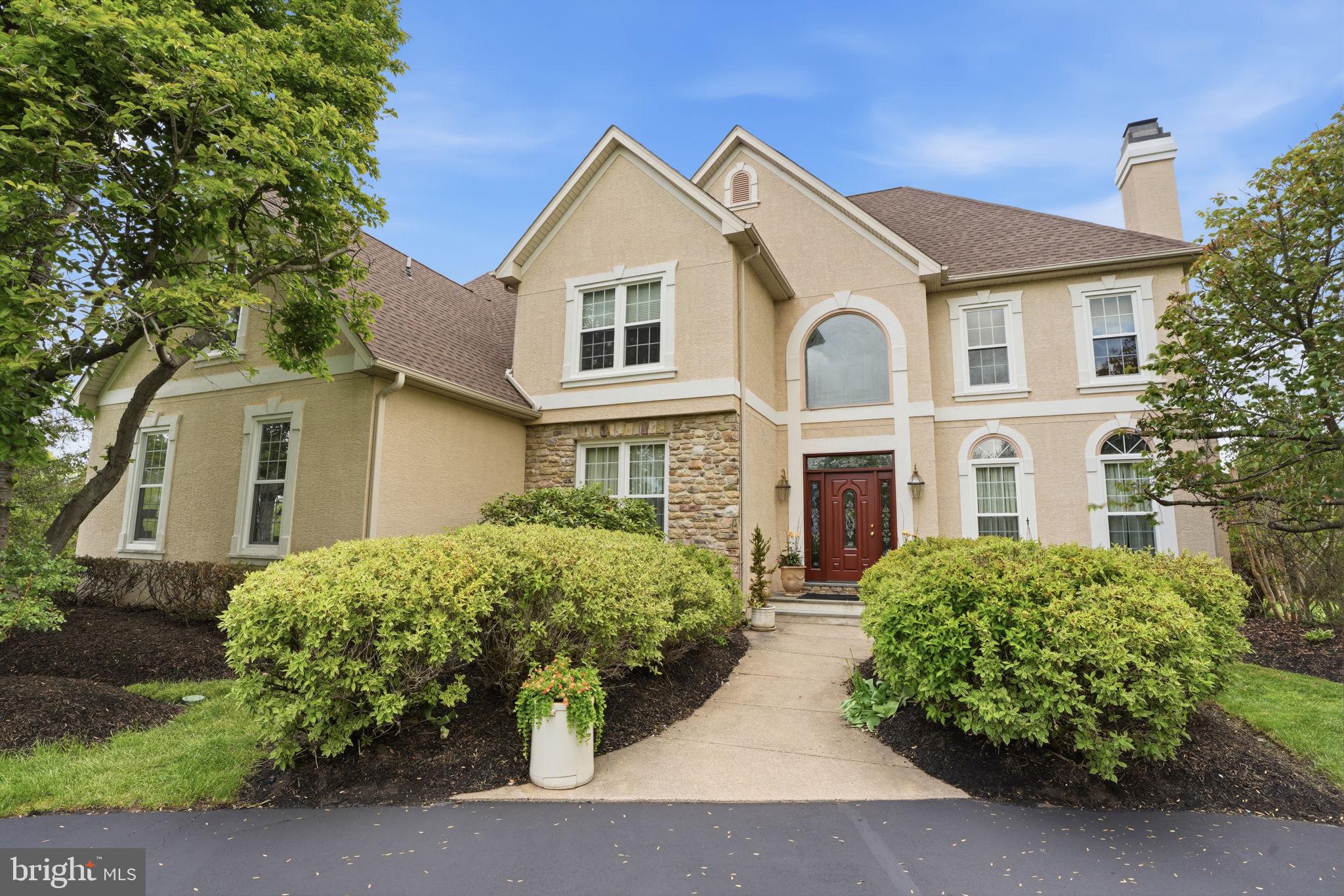 Set on a pristine 1-acre lot in the premier Deerfield community, this elegant colonial offers over 4,100 square feet of refined living in a quiet, upscale neighborhood known for its privacy and convenience. A circular driveway and side-entry three-car garage create a striking first impression, while the inviting front entrance with leaded glass door and transom opens to a dramatic two-story foyer, highlighted by a palladium window, hardwood floors, and a graceful staircase.
Designed for both everyday living and memorable entertaining, the home features formal living with marble fireplace and dining rooms adorned with hardwood flooring and detailed moldings including crown, chair rail, and wainscoting. The heart of the home is the gourmet kitchen, complete with a center island, stainless steel appliances, tiled backsplash, double pantry, and a sunlit breakfast area.
Just beyond, a step-down two-story family room impresses with a floor-to-ceiling stone fireplace and a convenient back staircase, flowing seamlessly into an oversized sunroom filled with natural light, soaring ceilings, and atrium-style leaded glass doors. A private first-floor office or library with built-in shelving, along with a laundry room and powder room, adds everyday functionality.
Upstairs, the luxurious primary suite offers a tray ceiling, a comfortable sitting area, and a spa-inspired bath with a jetted tub. Three additional spacious bedrooms and well-appointed baths complete the upper level. The partially finished lower level provides flexible recreation space while still offering abundant storage.
Outdoors, mature plantings and elegant landscaping surround a freshly painted custom deck—perfect for relaxing or entertaining in a serene setting. Ideally located near shopping, dining, historic downtown attractions, and major commuter routes, and served by the highly regarded Council Rock School District, this home seamlessly blends timeless design, modern comfort, and an exceptional location.