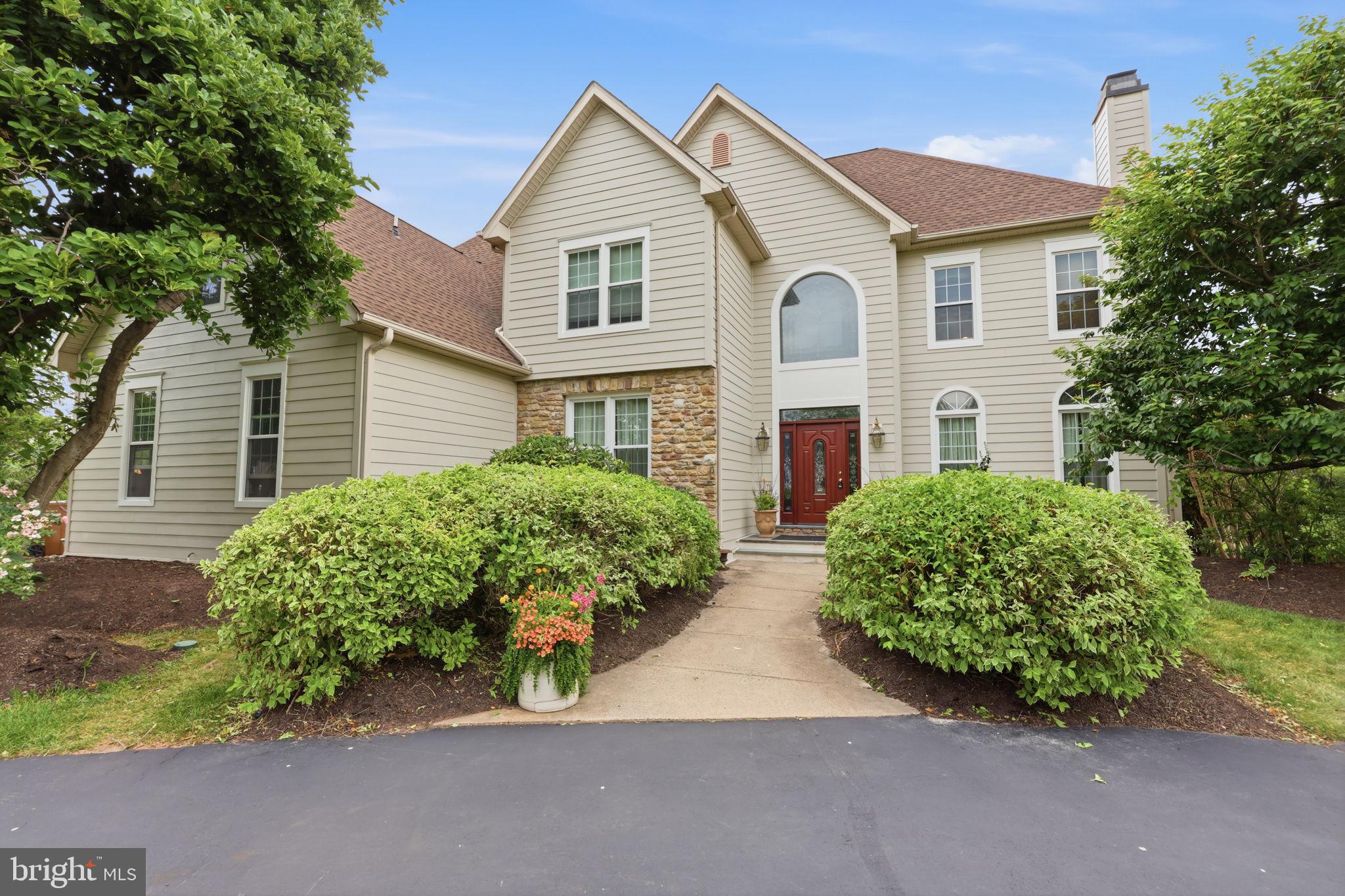 Set on a pristine 1-acre lot in the premier Deerfield community, this elegant colonial offers over 4,100 square feet of refined living in a quiet, upscale neighborhood known for its privacy and convenience. A circular driveway and side-entry three-car garage create a striking first impression, while the inviting front entrance with leaded glass door and transom opens to a dramatic two-story foyer, highlighted by a palladium window, hardwood floors, and a graceful staircase.
A major exterior improvement includes the complete replacement of the front stucco façade with premium Hardie Plank fiber-cement siding, enhancing both the exterior charm and long-term durability while providing a modern, low-maintenance exterior, and timeless architectural appeal.
Designed for both everyday living and memorable entertaining, the home features formal living with marble fireplace and dining rooms adorned with hardwood flooring and detailed moldings including crown, chair rail, and wainscoting. The heart of the home is the gourmet kitchen, complete with a center island, stainless steel appliances, tiled backsplash, double pantry, and a sunlit breakfast area.
Just beyond, a step-down two-story family room impresses with a floor-to-ceiling stone fireplace and a convenient back staircase, flowing seamlessly into an oversized sunroom filled with natural light, soaring ceilings, and atrium-style leaded glass doors. A private first-floor office or library with built-in shelving, along with a laundry room and powder room, adds everyday functionality.
Upstairs, the luxurious primary suite offers a tray ceiling, a comfortable sitting area, and a spa-inspired bath with a jetted tub. Three additional spacious bedrooms and well-appointed baths complete the upper level. The partially finished lower level provides flexible recreation space while still offering abundant storage.
Outdoors, mature plantings and elegant landscaping surround a freshly painted custom deck—perfect for relaxing or entertaining in a serene setting. Ideally located near shopping, dining, historic downtown attractions, and major commuter routes, and served by the highly regarded Council Rock School District, this home seamlessly blends timeless design, modern comfort, and an exceptional location.