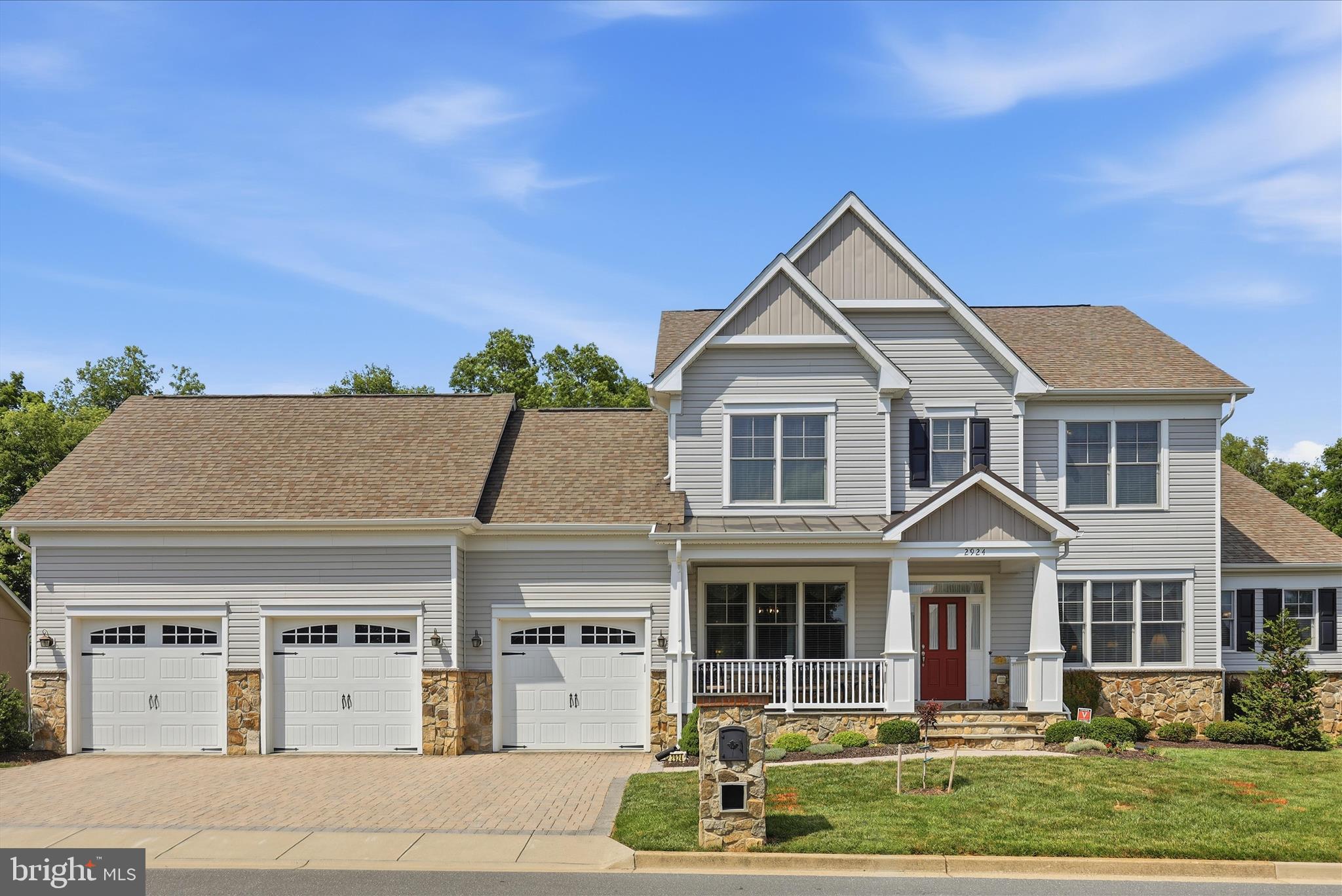 This custom WATERFRONT luxury home offers everything you could want, combined with the resort-style lifestyle that makes Worman's Mill so desirable. Enjoy peaceful mornings watching kayakers glide down the Monocacy River from your breakfast room, or sip coffee on the expansive 12' x 18 1/2' Trex deck, or cozy side porch while taking in views of fishermen casting along the water.

From the moment you step onto the covered front porch and enter the grand foyer, you'll be impressed by the soaring two-story ceilings in the atrium and family room. The spacious living and dining rooms feature beautiful hardwood flooring, creating an elegant setting for everyday living and entertaining.

The stunning family room is highlighted by a beautiful gas fireplace and an abundance of windows that frame breathtaking the views. The upgraded gourmet kitchen is designed to impress, featuring a massive 10.5' x 4.5' quartz-topped island comfortably seating 6, a stylish ceramic backsplash, upgraded cabinetry, and GE Profile stainless steel appliances, including a five-burner gas cooktop, double convection wall ovens, side-by-side refrigerator with ice and water dispenser, dishwasher with hidden controls, and more. A large pantry, mudroom, coat closet, and linen closet add convenience and functionality.

The luxurious main-level primary suite offers three spacious closets and a spa-inspired bath with dual vanities, an oversized walk-in shower, and a freestanding soaking tub.

Ascending the hardwood staircase with custom runner, you'll find three generously sized bedrooms, including one with an en-suite bath, plus an additional full hall bath.

The enormous unfinished lower level provides endless possibilities and includes a full bath rough-in, plumbing for a wet bar or kitchenette,  large window, and two walkout exits, making it ready for your custom design and future expansion.

The original owners invested extensively in premium upgrades, including Andersen 400 Series tilt-wash double-hung windows with full screens, an upgraded sliding door, Trane furnaces and thermostats, a whole-house humidifier, and additional R-19 insulation in the oversized three-car garage. The garage also features insulated doors with openers. Additional enhancements include the side atrium door, a private side deck area, and custom shelving throughout the home—no wire shelving here.

Residents enjoy exceptional community amenities, including swimming pools, scenic paved walking trails through the preserve, tennis and pickleball courts, basketball courts, a putting green, playgrounds, beautiful water features, and a clubhouse featuring a fitness center, library, and billiards room. Launch your kayak, canoe, or tube directly from Bluebell Path and embrace the waterfront lifestyle.

The vibrant Town Center serves as the heart of the neighborhood, where residents gather to enjoy live weekend music, community events, food trucks, and outdoor dining. Choose from three neighborhood restaurants and enjoy al fresco dining just moments from your doorstep.

This exceptional waterfront home combines luxury, comfort, thoughtful upgrades, and an unmatched lifestyle in one of Frederick's most sought-after communities.