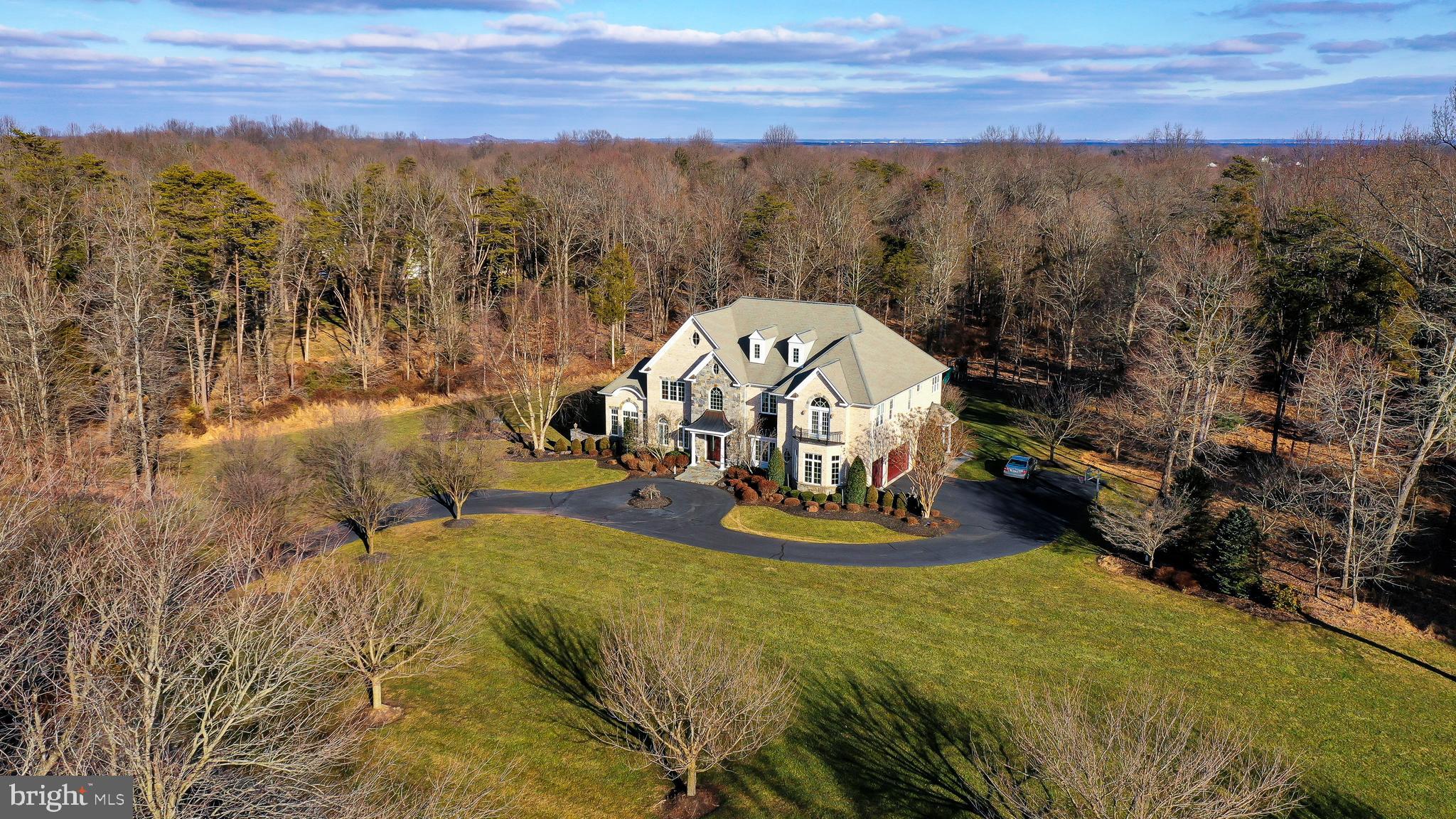 WOW! Incredible curb appeal with this exquisite 10 acre estate in the exclusive Piedmont Riding Club gated community.  Ornamental tree-lined driveway with custom, exquisite landscaping everywhere. Gorgeous stone and brick house, custom built with phenomenal trim and detail throughout. Start with a two-story grand foyer with curved staircase and travertine stone floor. Nearby gorgeous living room features a formal fireplace flanked by arched doorways that lead into a sunny conservatory/office space. Coffered ceilings highlight the family room that features its own fireplace, palladium windows, and decorative columns. Rich Brazilian cherry hardwood floors throughout main level. Gigantic kitchen with upgraded appliances, granite counters, grand center island, walk-in pantry and more! Beautiful backyard views through sun room extension with palladium windows. Spacious master suite has gas fireplace, his and her walk-in closets, and a grand master bath with large 2 person, dual-head shower and soaking tub with jets. 4 more large bedrooms on upper levels with 3 full bathrooms. Finished walk-out basement loaded with features including- theater room, gas fireplace, bedroom, full bath, kitchen and wine room. Riding Club is part of the Piedmont community - includes fitness center, pools, tennis courts, golf course, club house.