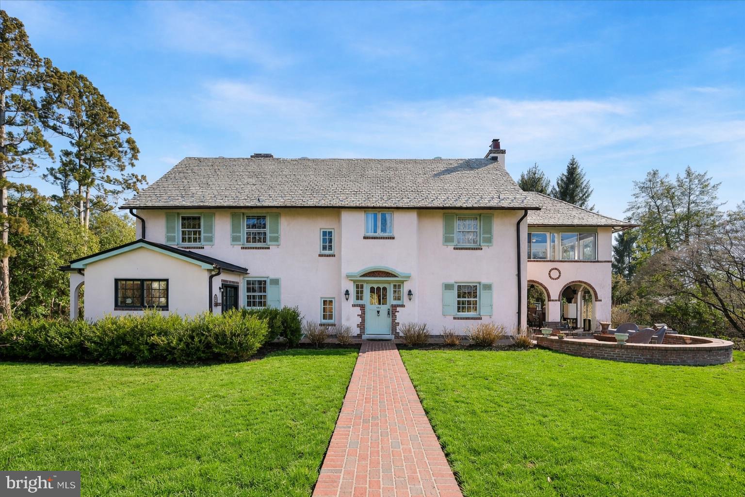 Tucked at the end of a quiet, tree-lined, dead-end lane, 490 Bancroft Lane offers a peaceful setting just steps from the train and a short walk to the heart of Media, known for its vibrant downtown, unique shops, restaurants, and strong sense of community. Built in 1910, the home blends classic character with thoughtful updates. Original details such as moldings, built-in china cabinets, and a fireplace add warmth, while the center hall layout allows natural light to flow from the formal living and dining rooms into the bright morning room. The home has been expanded and improved over time to enhance both comfort and functionality. A large kitchen addition serves as the central gathering space, and the finished basement provides flexible room for work, recreation, or storage. The primary suite includes a dressing area, spacious bathroom, and sun porch. Outside, the property features a newer pool, mature landscaping, a stone fish pond, and multiple spaces for relaxing or entertaining, including a brick patio and an open-air porch with a bar. The fully fenced yard also includes a detached two-car garage. The location offers easy access to everything Media has to offer, along with a convenient commute to Philadelphia by train. Situated in the award-winning Rose Tree Media School District, 490 Bancroft Lane offers the space, setting, and location that make it easy to feel at home.
