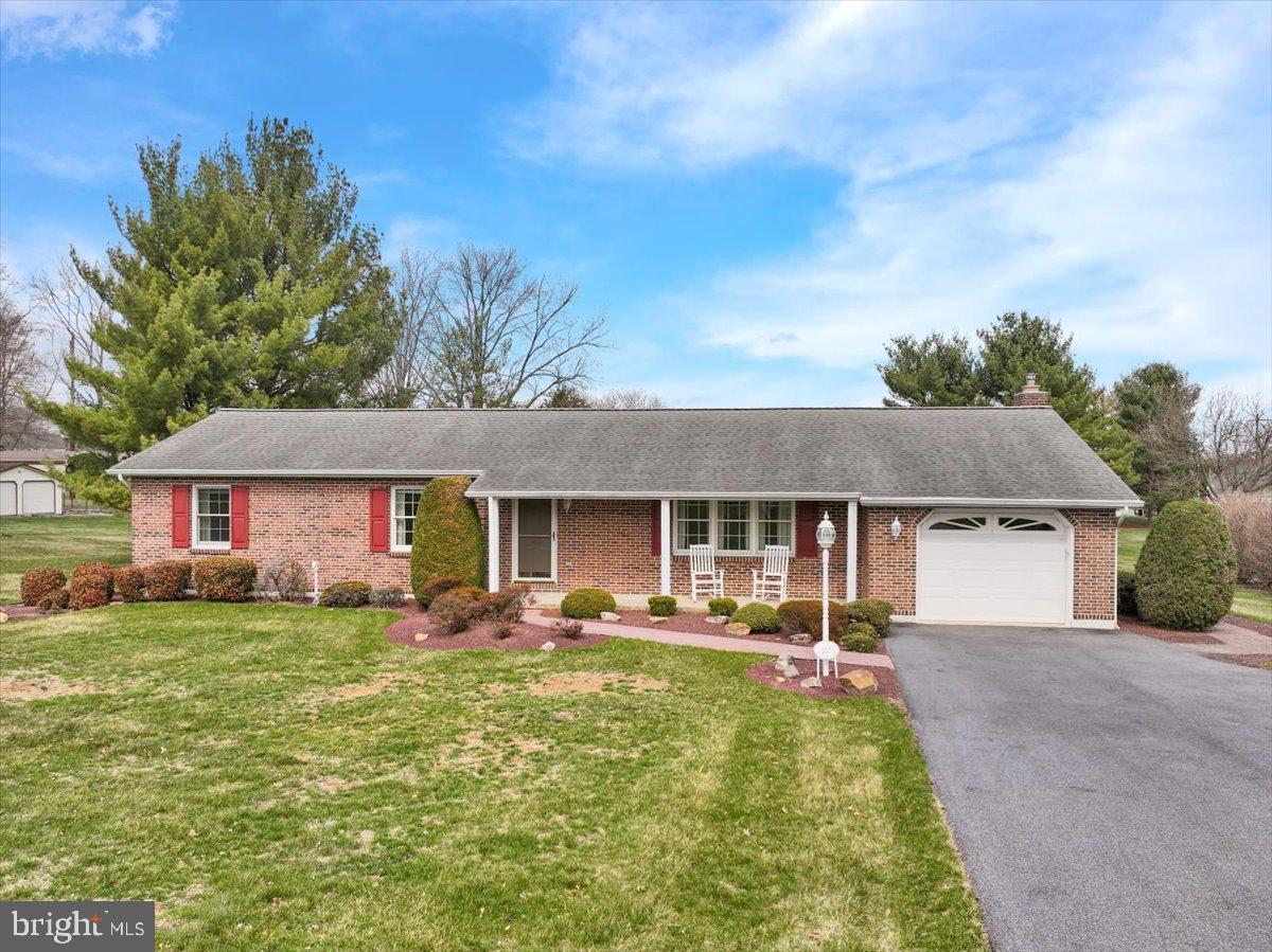 Welcome to this charming and spacious ranch home, beautifully situated on over an acre in the sought-after Conrad Weiser School District! This property offers 4 bedrooms and 2 full bathrooms, providing ample space for comfortable living. The inviting family room features a cozy brick-surrounded wood stove. The bright white kitchen, equipped with modern appliances, flows effortlessly into the dining room, where gleaming hardwood floors create a warm atmosphere. Enjoy the convenience of main-floor laundry and appreciate the quality of Anderson tilt-in windows throughout. The home boasts many recent upgrades, ensuring peace of mind for years to come. Step outside onto the expansive deck, ideal for entertaining or simply soaking in the serene views of the level lot, which is beautifully framed by professional landscaping and picturesque farmland across the way. Includes brick walkways and a large shed with covered wood storage.  The property also includes versatile basement workshop — a dream for hobbyists and DIY enthusiasts alike. This home also features an attached garage for extra convenience. Don’t miss this rare gem — a perfect blend of charm, comfort, and practicality, with plenty of space to enjoy both inside and out!