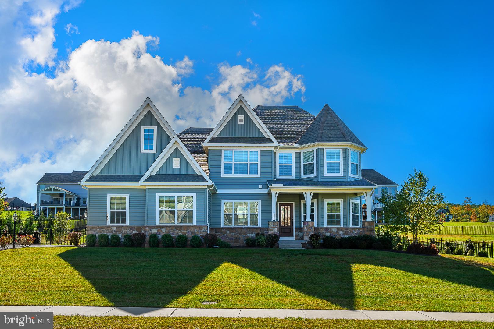 Tucked within the esteemed Ventry Community at Edgemont Preserve, 108 Parkview Way presents a tranquil retreat embraced by the beauty of its natural surroundings. This custom-built Nottingham model, only three years old, offers an understated elegance from the moment you arrive. A welcoming front porch introduces a home thoughtfully designed for both comfort and refined living.
Upon entry, the foyer gracefully opens into a spacious dining room with a charming bay window on one side and a private office with glass pocket doors on the other. The expansive living room, anchored by a gas fireplace, flows seamlessly into a gourmet kitchen. Designed for both culinary creativity and casual gatherings, the kitchen features double ovens, a butler’s pantry, and another bay window in the breakfast nook, adding to its airy appeal. A sunroom leads out to an expansive Timbertech deck, while the patio—complete with a built-in fire pit—provides an ideal spot to unwind, surrounded by lush landscaping and serene views.
The primary suite, located on the main floor, offers both seclusion and convenience. Two walk-in closets lead to a luxurious master bath, where a freestanding soaking tub, a spacious shower with dual heads, and twin vanities create a spa-like atmosphere. The laundry room, discreetly positioned near the garage entrance, offers easy access from both the primary suite and the rest of the home.
Upstairs, a large loft serves as a versatile space, flanked by three additional bedrooms, each with generous walk-in closets. The hall bath, equipped with double sinks and ample storage, serves the upper floor, while a bay window highlights the front-facing bedroom.