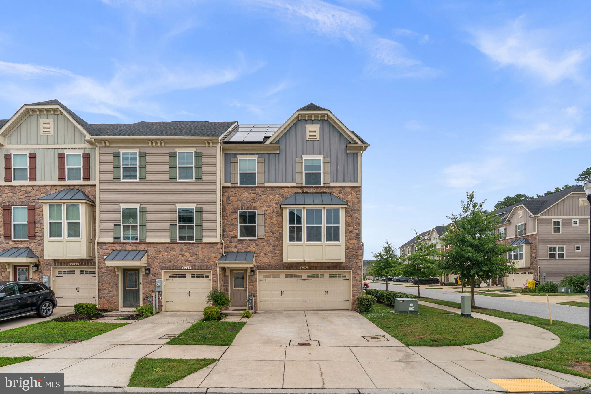 Welcome to this beautifully upgraded 3-story, end-unit craftsman townhome in Creekside Village. The spacious main level has a room that can be used for a rec room, game room, home office, or additional living area. A glass door opens to a beautifully stamped-concrete patio and a fully fenced backyard, creating a private outdoor retreat for effortless outdoor living, entertaining, and roasting s'mores by the fire pit. This level has a half bath and access to the 2-car garage. 

The second level features an open floor plan with stunning wood floors throughout. The gourmet kitchen is a chef's dream, with granite countertops, stainless steel appliances, a pantry, an expansive center island with barstool seating, tile backsplash, as well as pendant and recessed lighting. There is also an attached dining area perfect for casual meals or hosting gatherings. The glass door leads to the low-maintenance deck where you can relax and unwind with your morning coffee and enjoy summer cookouts. The spacious living room has oversized windows that fill the home with natural light, making it the perfect place to relax and watch TV or entertain guests.

The top floor has a large primary bedroom with a walk-in closet with custom organizers and an ensuite bath featuring a double vanity, ceramic tiled shower and soaking tub. Two generously sized bedrooms with ample closet space and a full bath are just down the hall.  A convenient laundry closet completes this level, adding to the home's functionality and ease of living.

This townhome has an attached 2-car garage with a private driveway that provide convenient parking and additional storage. The solar panels are owned and provide lower energy bills with no lease agreements or extra costs and will be transferred to the new owners - an added bonus!

Creekside Village offers an array of amenities, including the community gym, outdoor pool, clubhouse, dog park, tot lots, picnic area, basketball courts, and trails. This home is conveniently located near shopping and dining with easy access to Routes 10, 100, 97, 695, and 295 for easy commuting and within close proximity to Baltimore, Ft. Meade and the BWI airport. Welcome home!