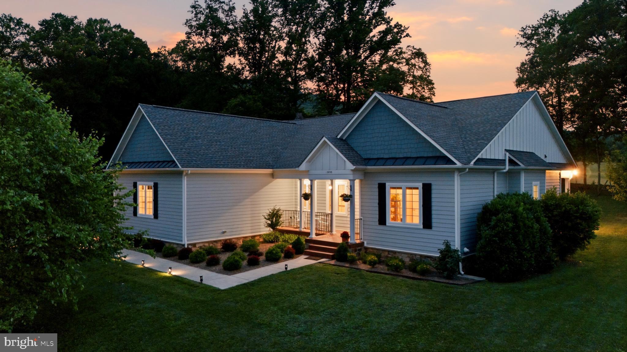 Welcome to elegant, turnkey 13855 Paris Breeze Pl, your exclusive, private happy place. Create a home of ease and beauty in this single level three bedroom, 2018 ranch stunner on 10.3 acres that effortlessly combines light, scale, and comfort. Paris Breeze sits at the convergence of community, wilderness, and agriculture, merging the best of all worlds. Whether it’s enjoying the cool mountain breeze and gazing at the meadow beyond the historic stone wall on the shaded, custom stamped back patio, hiking into your woods on cleared trails to lose your mind and find your soul, hosting cozy neighborhood gatherings around the fire pit, or starting your own viniculture project, this property has it all and does it with style. 
Paris Breeze features fully upgraded ceiling fans and light fixtures, upgraded primary bath barn doors, a new storage shed, updated landscaping hugging the home perimeter and throughout the front and back yard, newly planted evergreen and native trees, Tree of Heaven removal, and more! Ample cabinet space, pantry, island, and gorgeous modern granite countertops grace the gourmet kitchen. HVAC has been regularly and recently serviced. In the versatile basement, 10ft ceilings lend an expansive feel. The lower level also features a rough in for plumbing and has been framed and wired for a fourth bedroom. Active Radon mitigation was installed in 2024, in addition to a new well pump still under warranty. Two main electric service panels at 200 amps each provide substantial power for a workshop or electricity for the shed. 
This home sparks joy! You are invited to come to the heart of wine country, imagine yourself unwinding on a soft summer evening after a rain, watching the sun set behind the mountain or stargazing while listening to water flow through the meandering creeks in your woods.