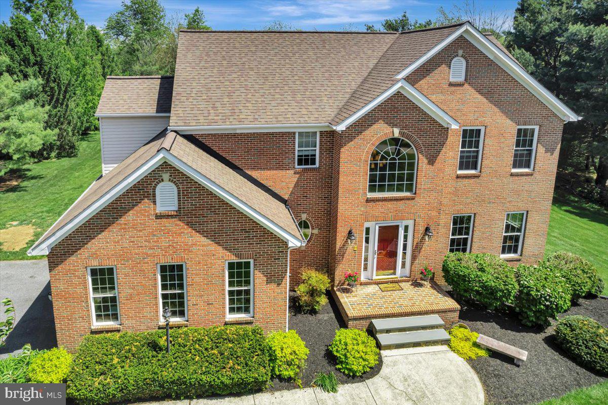 OPEN HOUSE TODAY SAT. June 20th  1-3pm.  Welcome to a home that offers the best of both worlds, featuring a level, exceptionally spacious and open backyard ideal for entertaining, recreation, and everyday enjoyment, paired with a front yard that showcases sweeping farmland views and unforgettable sunsets. The backyard is a true outdoor entertaining dream, complete with a brick firepit, generous space for gatherings and outdoor activities, a peaceful natural backdrop, and room to further customize outdoor living. The thoughtfully landscaped and well maintained lawn enhances both settings, adding to the home’s impressive overall presentation. Tucked away on a quiet street serving only a handful of homes, this property offers a rare combination of privacy, open space, and a setting that provides a sense of added comfort and peace of mind. This exceptional 4 bedroom, 4 bath Colonial, built in 1997, features an elegant all brick front with a broad brick terrace style front porch and offers approximately 4,500 square feet of living space.

Step into a bright and welcoming interior highlighted by a grand two story foyer with elegant accent molding that sets an impressive tone from the moment you enter. The open concept layout features a spacious family room with a gas fireplace, creating a warm and inviting atmosphere, while the eat in kitchen overlooks both the family room and breakfast area. The kitchen includes granite countertops, a center island, abundant 42 inch maple cabinetry with soft close doors, tile backsplash, and stainless steel appliances. It flows into a sun filled breakfast room with numerous windows and direct access to a large maintenance free deck overlooking the private rear yard. A separate living room, formal dining room, convenient main level laundry, and powder room add both flexibility and functionality, while hardwood flooring extends throughout the entire upper level. The primary suite offers a private retreat with a sitting area, vaulted ceiling, and a spa inspired bath featuring a tiled glass shower, jetted soaking tub, and dual vanities. Secondary bedrooms are generously sized, including an expansive second bedroom with a vaulted ceiling and sitting area, and the updated hall bath includes ceramic tile flooring, a dual vanity, and quartz countertops.

The finished basement provides high ceilings, ample natural light, wide rear entry stairs, an open entertainment area, a full bath, and dedicated storage and utility rooms for added versatility. Additional features include architectural roof shingles installed in 2021 with a transferable warranty, a two car side load garage, a detached rear shed, zoned HVAC, a sump pump, and an owned 100 gallon propane tank servicing the fireplace. A one year home warranty is included for added peace of mind. Ideally located near shopping, dining, parks, and major commuter routes, this home offers easy access to I 795, I 695, Route 97, and Route 26, along with convenient proximity to Baltimore, Howard County, Frederick, and Hanover, Pennsylvania, making it a rare opportunity to enjoy space, comfort, and scenic beauty in a highly desirable setting. Experience all this exceptional property has to offer.  Some images may include virtual staging.