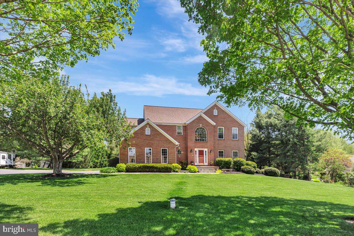 Welcome to a home that offers the best of both worlds, featuring a level, exceptionally spacious and open backyard ideal for entertaining, recreation, and everyday enjoyment, paired with a front yard that showcases sweeping farmland views and unforgettable sunsets. The backyard is a true outdoor entertaining dream, complete with a brick firepit, generous space for gatherings and outdoor activities, a peaceful natural backdrop, and room to further customize outdoor living. The thoughtfully landscaped and well maintained lawn enhances both settings, adding to the home’s impressive overall presentation. Tucked away on a quiet street serving only a handful of homes, this property offers a rare combination of privacy, open space, and a setting that provides a sense of added comfort and peace of mind. This exceptional 4 bedroom, 4 bath Colonial, built in 1997, features an elegant all brick front with a broad brick terrace style front porch and offers approximately 4,500 square feet of living space.

Step into a bright and welcoming interior highlighted by a grand two story foyer with elegant accent molding that sets an impressive tone from the moment you enter. The open concept layout features a spacious family room with a gas fireplace, creating a warm and inviting atmosphere, while the eat in kitchen overlooks both the family room and breakfast area. The kitchen includes granite countertops, a center island, abundant 42 inch maple cabinetry with soft close doors, tile backsplash, and stainless steel appliances. It flows into a sun filled breakfast room with numerous windows and direct access to a large maintenance free deck overlooking the private rear yard. A separate living room, formal dining room, convenient main level laundry, and powder room add both flexibility and functionality, while hardwood flooring extends throughout the entire upper level. The primary suite offers a private retreat with a sitting area, vaulted ceiling, and a spa inspired bath featuring a tiled glass shower, jetted soaking tub, and dual vanities. Secondary bedrooms are generously sized, including an expansive second bedroom with a vaulted ceiling and sitting area, and the updated hall bath includes ceramic tile flooring, a dual vanity, and quartz countertops.

The finished basement provides high ceilings, ample natural light, wide rear entry stairs, an open entertainment area, a full bath, and dedicated storage and utility rooms for added versatility. Additional features include architectural roof shingles installed in 2021 with a transferable warranty, a two car side load garage, a detached rear shed, zoned HVAC, a sump pump, and an owned 100 gallon propane tank servicing the fireplace. A one year home warranty is included for added peace of mind. Ideally located near shopping, dining, parks, and major commuter routes, this home offers easy access to I 795, I 695, Route 97, and Route 26, along with convenient proximity to Baltimore, Howard County, Frederick, and Hanover, Pennsylvania, making it a rare opportunity to enjoy space, comfort, and scenic beauty in a highly desirable setting. Experience all this exceptional property has to offer.  Some images may include virtual staging.