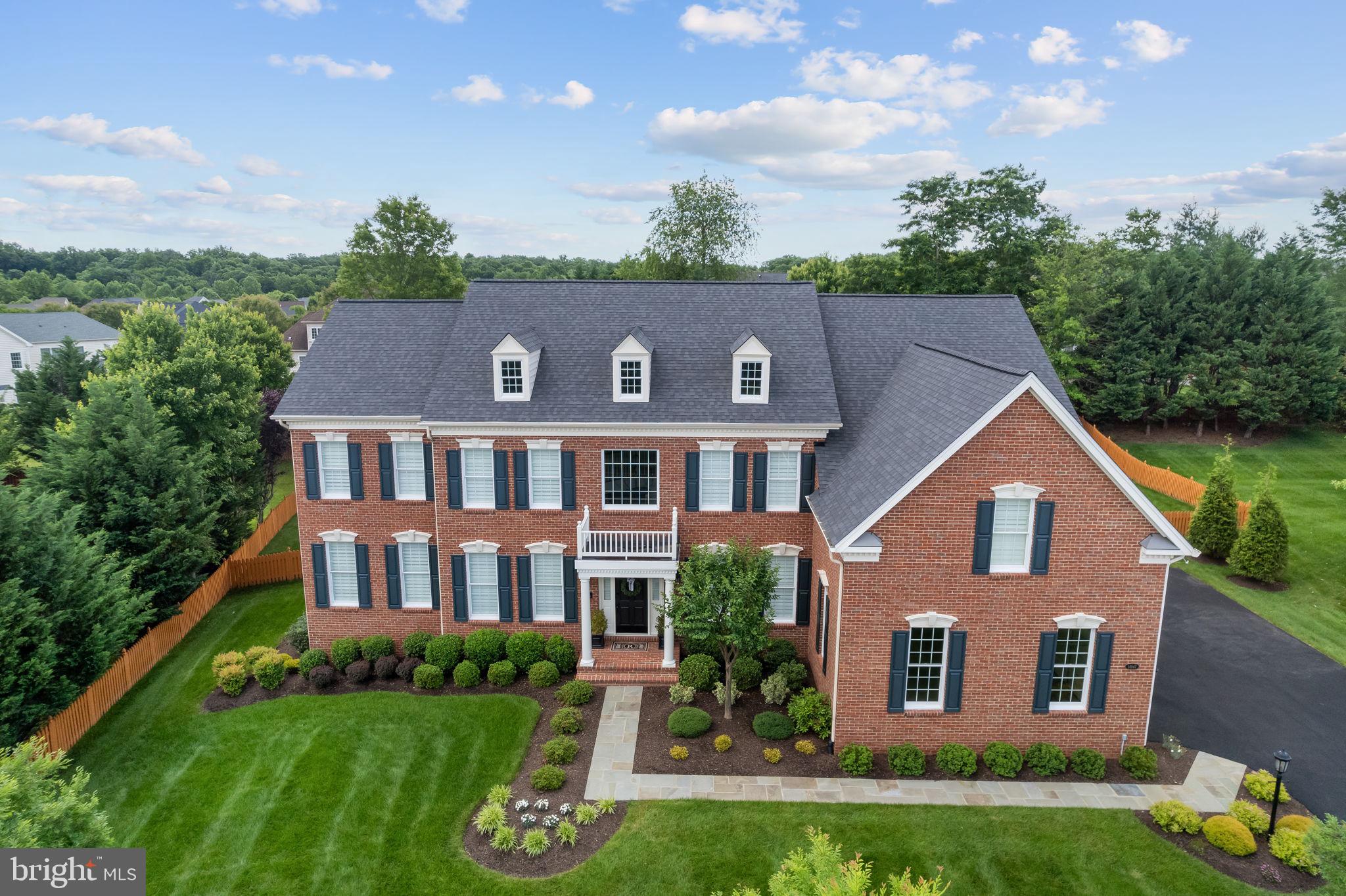 Exquisite colonial located in the highly desirable, award winning golf community of Dominion Valley. This immaculate 7104 sq ft estate home with 5 bedrooms and 6.5 bathrooms has been COMPLETELY REMODELED, (starting 2021 to completion at the end of 2023). Upon entering you will be greeted with new 8 ½ inch European oak engineered hardwoods, an oversized wrought iron chandelier, new stair railings/posts, refinished stairs, and custom trim package. Off the formal living room. The sunroom has newly installed French glass doors, high end carpet(installed 5/2024) and fan. The dining room features a new flush mount light and in close proximity a coffee/wine bar with new glass adorned cabinets for display, quartz countertop, marble backsplash, under cabinet lighting and wine fridge. The home office features a newly refinished and painted bookcase, newly installed glass French doors and fan. The oversized family room has a stone gas fireplace and a new energy efficient ceiling fan. Adjacent to the family room-the chefs kitchen has custom cabinets with soft close doors and drawers that extend to the ceiling, stainless steel Jenn Air appliances that features a dual fuel range with 6 burners and griddle, cabinet depth oversized refrigerator, in island microwave and dishwasher. In addition, the kitchen also boasts a pot filler, marble decorative and subway tile backsplash, under cabinet lighting, quartz countertops, all new lighting, and fans. The kitchen's fireplace surround has been re-tiled in matte black marble. The powder room has a new vanity with soft close doors, quartz countertop, new lighting, exhaust fan, toilet, mirror, and finishes. The laundry room has newly installed upper cabinets with soft close doors, crown molding, patterned tile floor and laundry tub. All new custom 4 ½ inch wide vinyl plantation shutters and door hardware throughout the main level. On the top floor, you will find newly installed high end patterned wall to wall carpeting(installed 5/2024). All bedrooms are oversized with new ceiling fans and their own newly remodeled bathrooms. All bathrooms have non scratch non slip tubs, tiling that extends to the ceiling, vanities with soft close drawers and doors, quartz countertops, bath fixtures, fans, toilets and flooring. The primary bathroom has new flooring, vanity, custom frameless shower, free standing tub, toilet, mirrors,  all new bath fixtures, lighting and fans. The primary bedroom has crown molding, new fan and huge walk in closet. The top floor has new custom 4 ½ inch wide energy efficient plantation shutters and door hardware throughout as well. On the basement level you will see newly installed patterned carpet(installed 8/2023), slate tile rear door flooring, custom trim package, and modernized bar. The bar features italian tile backsplash, cabinets with soft close doors and drawers, quartzite countertops, composite sink and beverage refrigerator. Bar flooring is waterproof 5 ½ inch luxury vinyl plank. The basement bathroom has new floor tile, vanity, mirror, toilet, lighting and fan. The shower features a black paneled glass door. The gym area has the same luxury vinyl plank as the bar area,  new fans and huge closets. The basement also has an oversized room that can be used as a theater room and huge storage room. All new door hardware, wall sconces and bar ceiling lighting as well. The basement is equipped with an in-ceiling sound system. New paint throughout the home. The exterior of the home has had a major transformation that includes the newest updates of a new roof (11/2023), new asphalt driveway (4/2024), garage floor epoxy and paint (4/2024). other updates are HVAC system and 80 gallon water heater replacement(11/2019) new garage doors, exterior lighting, updated landscaping with new plants and privacy trees near the driveway, exterior paint,  flagstone walkways (front & rear) and flagstone extension of rear paver patio, new TREXX deck. 10 zone irrigation system updated with new heads.