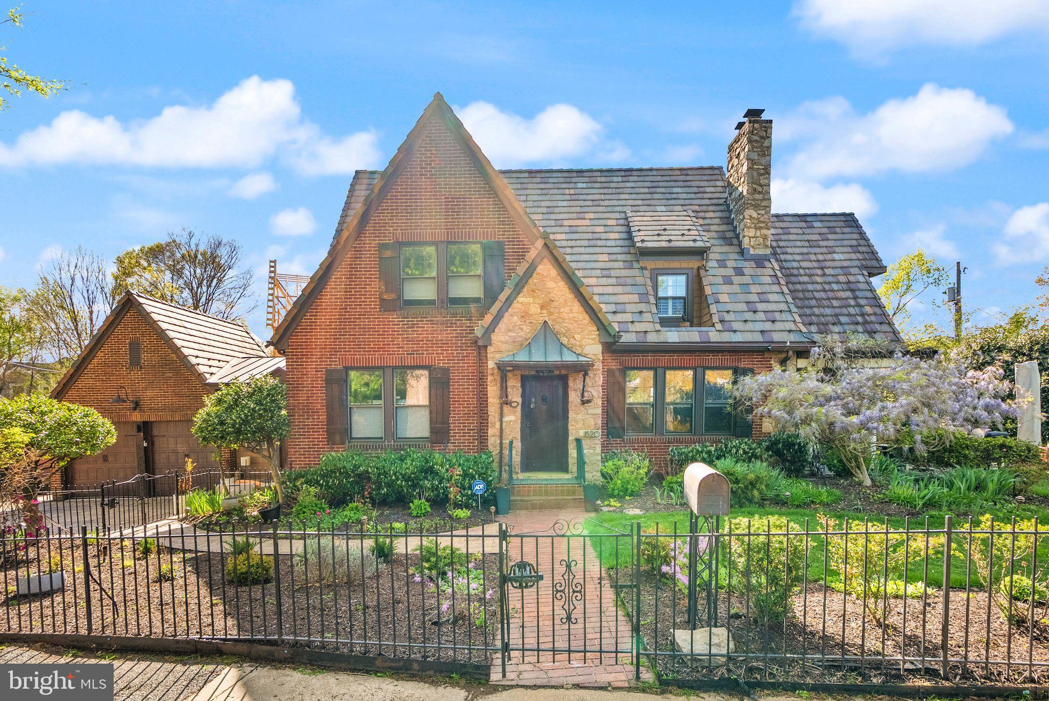 Rare gem in the heart of Lyon Village, a beautifully preserved 1928 Tudor with 4 bedrooms, 3 full bathrooms, and 2,459 finished square feet of timeless character and modern comfort. Set on a massive .23-acre lot just two blocks from the Clarendon Metro, this home offers the perfect blend of historic charm and unbeatable location. From the moment you arrive, you’ll be captivated by the Italian slate roof, elegant stone driveway, and iron-fenced yard with mature privacy plantings. Inside, original woodwork and a striking stone fireplace create a warm, inviting atmosphere, while the sun-drenched main level features a flexible bedroom or home office with a full bath, perfect for guests or remote work.The eat-in kitchen is outfitted with stainless steel appliances, granite countertops, and an oversized walk-in pantry that leads to a convenient mudroom and attached two-car garage. Upstairs, three additional bedrooms and two full bathrooms offer plenty of space to spread out. Outside, two separate patios provide idyllic spaces for lounging or entertaining under the stars. Additional highlights include a bright bonus sunroom, thoughtfully landscaped outdoor spaces, and the unbeatable walkability of Lyon Village, just moments from dining, shopping, parks, and transit. Storage includes a 949 sqft unfinished basement and walk-up attic. This is a truly special home in one of Arlington’s most coveted neighborhoods. Don’t miss the opportunity to make it yours.