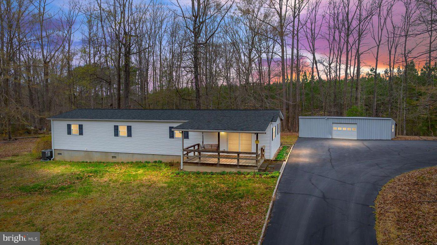 Secluded Comfort Meets Modern Convenience – 5900 Paynes Ln, Spotsylvania, VA 22551 - Tucked away on 2.8 acres of serene, partially wooded land, this charming 4-bedroom, 2-bathroom home offers the perfect blend of privacy and convenience. Surrounded by nature and backing onto vast private wooded land, this 1,340 sq. ft. retreat provides a peaceful escape while remaining just minutes from shopping, dining, Interstate 95, Dominion Raceway, and the upcoming Kalahari Resort. Step inside to discover a traditional layout with thoughtful updates, including vinyl plank flooring, LED lighting, and a spacious eat-in kitchen. The kitchen boasts tons of cabinet space, a separate freezer, and a new refrigerator (2022), making it a dream for meal prep and entertaining. The family room’s sliding glass doors open to a huge front porch, inviting you to enjoy your morning coffee with the sounds of nature. The primary suite is a private retreat, featuring an attached bath, walk-in closet, and exclusive access to a secluded deck—perfect for unwinding after a long day. Three additional bedrooms provide ample space for guests, a home office, or hobbies.  Outside, the property shines with multiple decks, a covered picnic shelter, vibrant flower gardens, and two storage sheds. A detached 35x15 garage with power offers endless possibilities for a workshop, extra storage, or vehicle parking. Recent updates include a new house roof (2023), metal garage roof (2021), and whole-house generator (2021), ensuring peace of mind for years to come.  Whether you're seeking a private homestead, a weekend retreat, or a peaceful country home with easy access to modern amenities, this meticulously maintained property is ready to welcome you home!📍 Don’t miss your chance to own this hidden gem! Schedule your showing today!