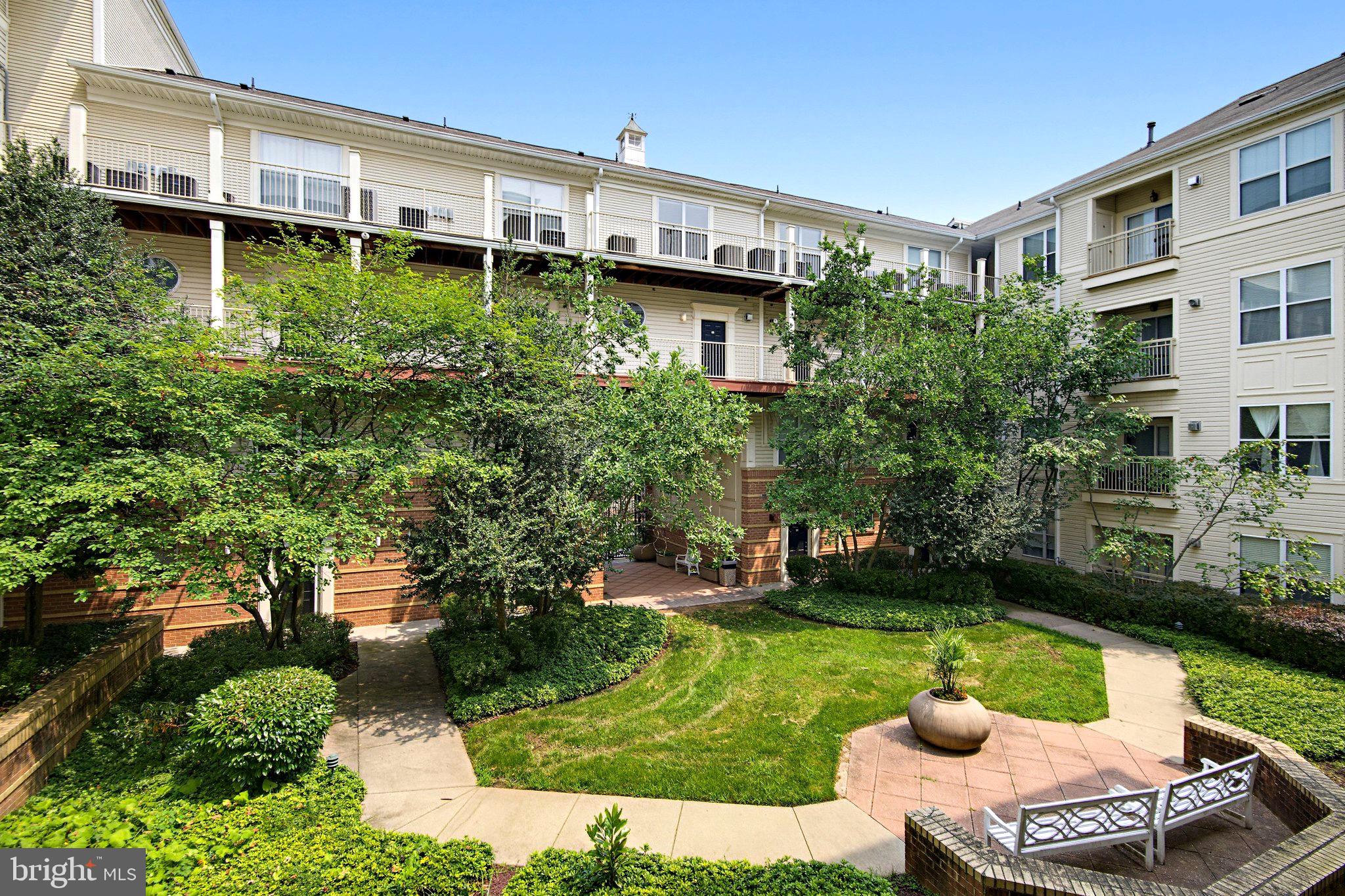 Beautifully maintained and move-in ready, this bright and spacious condo features an open floor plan with soaring ceilings, fresh paint throughout, professionally cleaned carpeting, and new luxury vinyl plank flooring in the kitchen and bathrooms. The kitchen offers a breakfast bar, gas cooking, a brand-new microwave, and abundant cabinet and counter space. A dedicated home office provides the perfect space for remote work.

Relax on your private covered balcony overlooking the beautifully landscaped courtyard. The spacious primary suite features a large walk-in closet, while additional highlights include in-unit laundry, secure garage parking, and ample storage.

Ideally located just steps from the Vienna/Fairfax-GMU Metro Station, with easy access to the Mosaic District, shopping, dining, I-66, and I-495. Residents enjoy outstanding amenities, including a resort-style pool, fitness center, clubhouse, billiards room, indoor basketball court, and beautifully landscaped common areas.