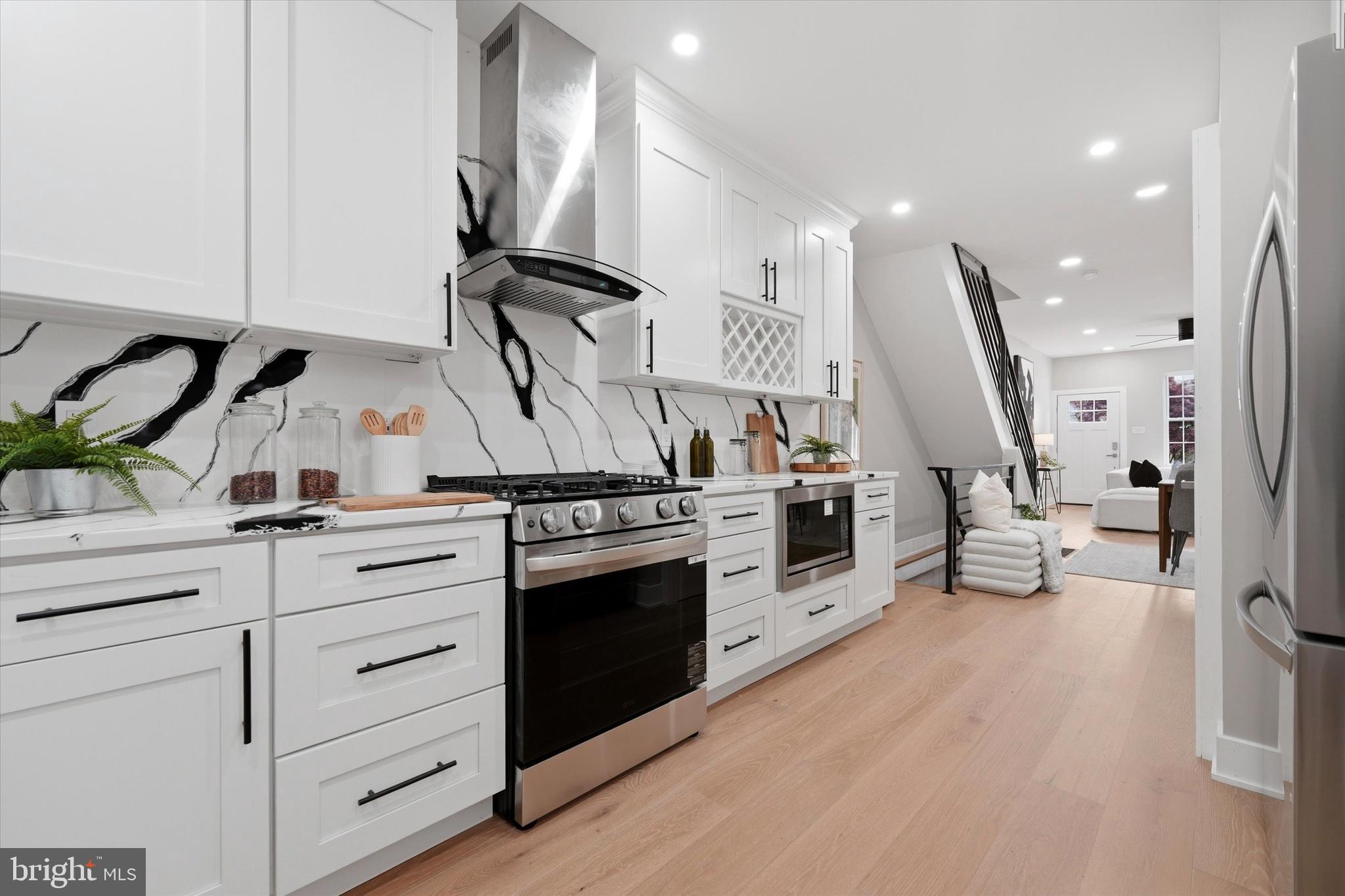 Stunning, fully remodeled three-story home in Philadelphia's trendy University City featuring 5 bedrooms and 2.5 bathrooms! Located in one of the city's hottest neighborhoods, this completely renovated residence offers modern luxury throughout with no detail overlooked. The first floor features beautiful engineered hardwood flooring, a convenient laundry room with washer and dryer included, a powder room for guests, and a gourmet kitchen showcasing quartz countertops and stylish backsplash.

The second floor boasts three spacious bedrooms and two full bathrooms, including a master bedroom with an en-suite bathroom for ultimate privacy and convenience. The third floor offers two additional bedrooms, perfect for family, guests, or home office space. Genuine hardwood floors grace both the second and third floors, adding warmth and elegance throughout the upper levels.

Recent upgrades include new HVAC, plumbing, electrical systems, roof, and energy-efficient windows—providing peace of mind for years to come. The semi-finished basement with durable LVP flooring offers additional living space and storage options.

Step outside to your lovely backyard, perfect for summer BBQs and outdoor entertaining. This turnkey home combines modern amenities with classic Philadelphia charm in the vibrant University City area. Don't miss this opportunity to own a completely rehabbed property that's move-in ready in one of Philadelphia's most desirable locations!