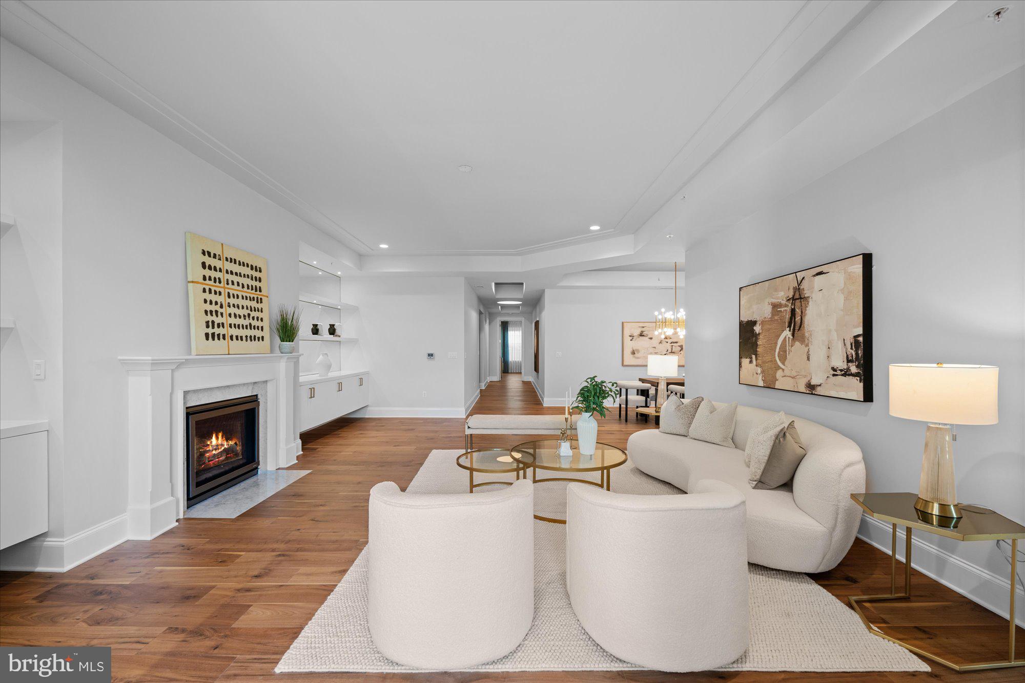**OPEN HOUSE, SUN, JUNE 14 1pm-3pm**Presenting the pinnacle of luxurious living: thE Builder's model at the exclusive Quarry Springs. Positioned in a serene enclave at the rear of this resort-style community, the residence is enveloped by meticulously landscaped gardens, a cascading waterfall, a picturesque gazebo, and a pristine pool. "The Montrose" floor plan offers an expansive 2,700 square feet of unparalleled interior living space, complemented by an additional 440 square feet of private, covered terraces that boast sweeping courtyard and pool vistas.
Arrival is a grand experience, with a private elevator opening directly into a magnificent foyer. The eye is immediately drawn to the premium 7-inch EcoTimber hardwood plank flooring and substantial 10-inch base moldings that anchor the space. Bespoke details abound, including lavish designer lighting fixtures, custom illuminated cabinetry, and a stately mantled gas fireplace. Elegant tray ceilings with recessed lighting further accentuate the impressive vertical volume throughout the home. From the adjoining formal living and family rooms, seamless access is granted to the first of two expansive covered terraces.
Offering two generously proportioned bedrooms, two and a half luxuriously appointed bathrooms adorned with custom designer wallcoverings, and a versatile family room, this residence represents the very quintessence of elegance. It is situated within a highly secure, gated Bethesda community, where residents enjoy the utmost privacy and exceptional service, including a dedicated gatekeeper, personal concierge, and doorman. Exclusivity is guaranteed, as Building Four is an intimate enclave comprising merely 24 units.
The culinary center is a masterpiece of both form and function. A true chef's kitchen, it features sleek, designer white Woodmont-style cabinetry by the Suss Group, beautifully contrasted by exquisite marble countertops. The suite of professional-grade appliances leaves nothing to be desired: a 42-inch Sub-Zero refrigerator, a 30-inch five-burner Wolf gas cooktop with an exterior-venting range hood, a 30-inch Wolf convection oven, a 24-inch Wolf convection microwave, and a discrete Sub-Zero under-counter wine and beverage preservation center. The space is flawlessly completed by a Bosch dishwasher, a stainless steel Waterworks faucet, and a Blanco under-mount sink.
The primary owner's suite is a private sanctuary, offering direct access to the second covered terrace and featuring expansive, custom-built closets. The accompanying en-suite bathroom is a spa-like retreat, boasting an oversized walk-in shower, a freestanding Waterworks soaking tub, and a dual-sink vanity swathed in pristine Carrara marble, all complemented by premium Waterworks and Toto fixtures. The secondary bedroom is equally inviting, featuring exquisite designer wallcoverings, access to the terrace, and a private en-suite flawlessly finished with high-end Waterworks and Toto accessories.
Practicality meets elegance in the dedicated laundry room, outfitted with pristine white cabinetry and an oversized washer and dryer. This space conveniently connects to a private rear service entrance, ideal for discreet personal deliveries. Adding to the effortless living experience, Unit 423 conveys two assigned parking spaces and a dedicated storage unit within the immaculate, secure underground parking garage.
Residents are afforded an unparalleled lifestyle with comprehensive amenities, meticulous custodial maintenance, high-speed internet, on-site management, and snow removal. The community features a state-of-the-art health club, beautifully manicured gardens, and expansive recreation and club facilities. Superbly located just blocks from major thoroughfares, with effortless access to Washington D.C., N.Virginia, and three international airports. Furthermore, enthusiasts will appreciate being less than 3 miles from the prestigious Congressional, Burning Tree,  Avenel & Bethesda Country Clubs