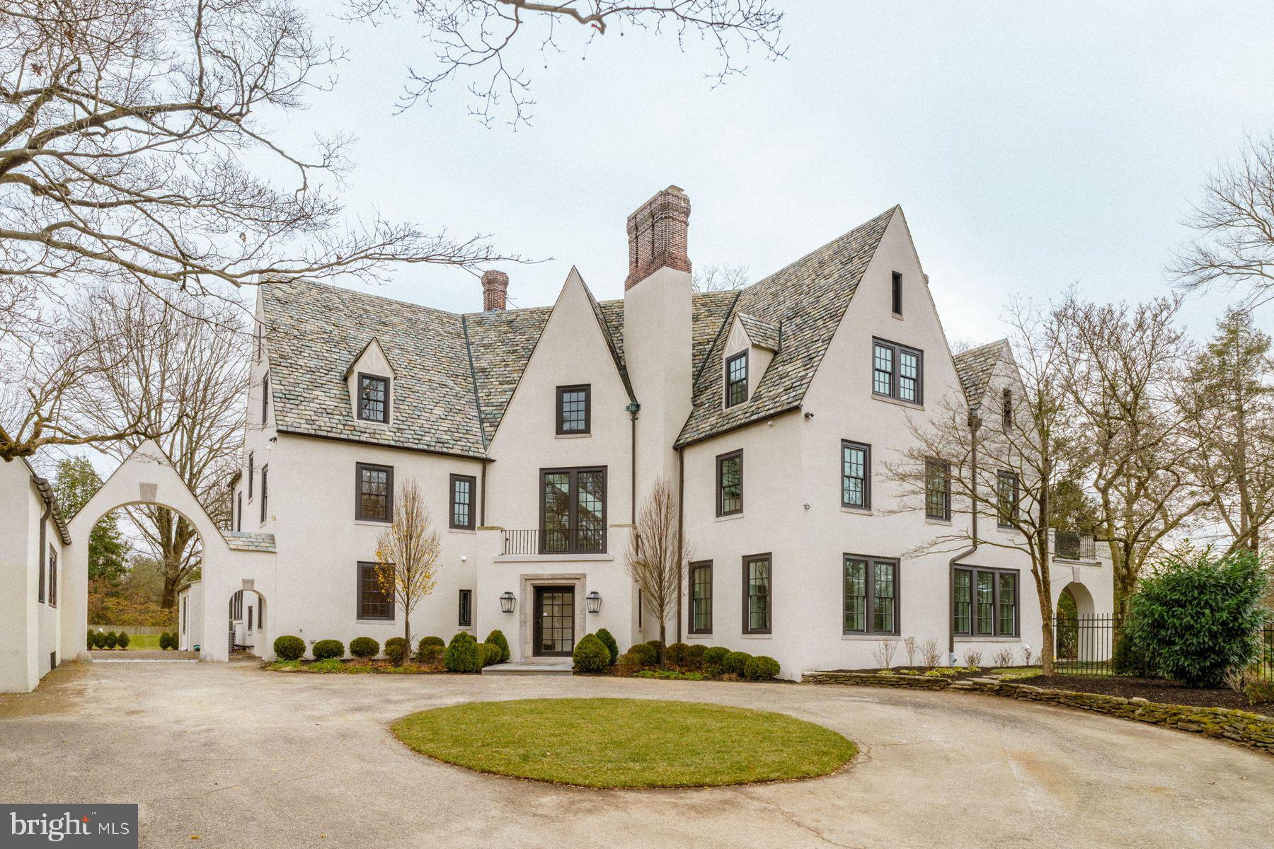 Turn the key and watch the magic unfold! Introducing a spectacular fusion of past and present at 422 W. Chestnut Hill Avenue, a masterfully reimagined estate by award-winning Blake Development Corporation. Set on .62 acres along the Wissahickon Valley, this 8,500+ square-foot residence seamlessly integrates timeless architectural character with modern luxury. Featuring 6 bedrooms, 6 full and 2 half baths plus versatile spaces ideal for home offices, this move-in ready home has been restored with exceptional craftsmanship and an uncompromising eye for detail.

This remarkable property carries a storied history. Originally part of Henry H. Houston’s 1880s Chestnut Hill development, it began as two Queen Anne–style dwellings built in 1884-1885 by architects G.W. & W.D. Hewitt. In 1925, Richard L. Austin commissioned Bunting & Shrigley to unify and transform them into an elegant L-shaped French villa with courtyard and 1.5 story oversized garage/loft; a wedding gift to his daughter, Lucille Austin Hepburn. Its evolution reflects a broader Chestnut Hill tradition of creatively adapting historic homes to suit modern needs while honoring their architectural soul.

The home’s approach is unforgettable with a bluestone entrance walkway, slate-clad gables, smooth stucco façades, and deep-set windows overlooking manicured gardens. Inside, a grand checkerboard-marble foyer leads to refined millwork, hardwood floors, and a sweeping staircase illuminated by tall arched windows. The main level blends elegance with everyday comfort. A stunning custom-designed kitchen with bespoke cabinetry, marble and granite surfaces, professional-grade appliances, and a dramatic island opens to a sun-filled great room with captivating views of the grounds. A stylish half bath, well-appointed mudroom, and secondary staircase enhance convenience. Formal living and dining rooms, each with architecturally detailed fireplaces, and a handsome den create a beautifully connected, thoughtfully curated main living experience. From the living room, double doors open to a flagstone terrace framed by graceful arches and a richly finished wood ceiling complete with an integrated radiant heating system allowing for year-round outdoor enjoyment overlooking the grounds.

The second level includes an exquisite primary suite with oversized custom-fitted walk-in closet and a showpiece marble bath crafted with timeless design and thoughtfully curated details. Beyond the primary suite, the level features two additional ensuite bedrooms and a substantial laundry room. The third floor offers four bedrooms and two full hall baths, ideal for guests or dedicated work and play spaces. The lower level provides unusually high ceilings, a flexible media, fitness, or recreation area with an integrated infrared sauna, full bath, walk-out access, and generous storage.

422 W. Chestnut Hill Avenue is more than a home…it’s a lifestyle, perfectly situated just steps from shopping, dining, and the scenic Wissahickon Trails. For those who travel frequently or enjoy weekend getaways, this home is strategically located to provide seamless access to New York City, Washington, D.C., and all the major airports.  422 W. Chestnut Hill Avenue is a place where sophistication meets comfort, where historic architecture meets modern luxury, and where all the hard work has been done for you. Just move in and continue writing the story of this remarkable estate!