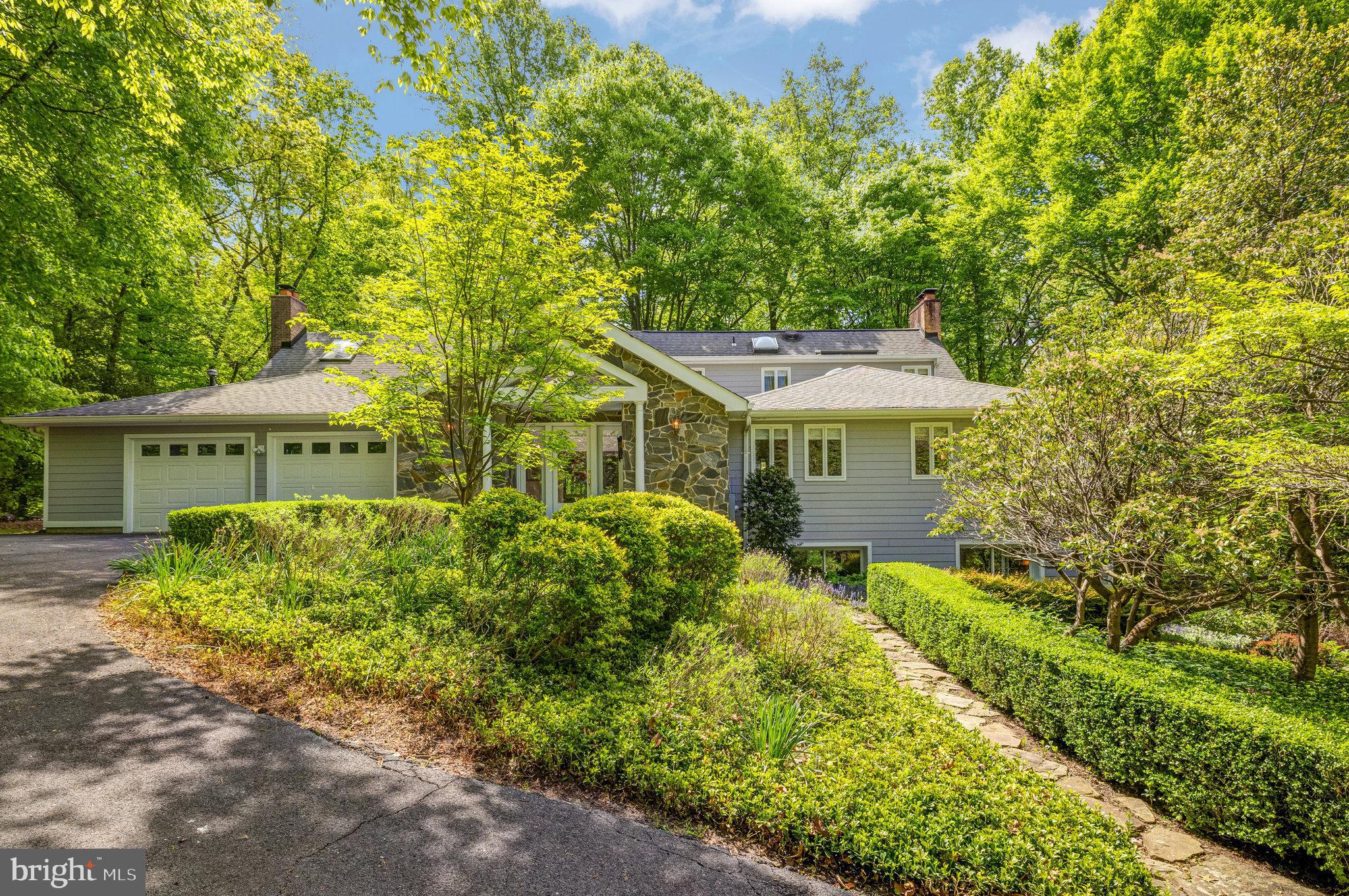Priceless Serenity!  Lovely, spacious, light-filled home is sited on natural wooded five acres with lush landscaping in premiere neighborhood of predominately five acre residential estate lots along the Potomac River off River Bend Road in desirable Great Falls.  The welcoming Grand Foyer, which includes a wet bar, opens to a tremendous 42' long Great Room with skylights, wall of glass doors and fabulous fireplace.  The large kitchen features granite counter eating space in addition to a breakfast area.  Inviting dining room has a fireplace and doors to the expansive deck which includes a built-in fireplace.  Additionally there is an en-suite bedroom , office and powder room on the main level.  The primary bedroom suite is on the upper level of the home highlighted by a spacious bedroom, sitting area with balcony overlooking the Great Room, double vanities, soaking tub, shower and water closet.  The lower level features a cozy walk-out family room with fireplace, two large bedrooms, full bath, laundry room and huge storage | utility area.  A great stone patio is an extension of the deck overlooking the treed vista.   This wonderful home was designed to enjoy and appreciate the splendor of peaceful living in a natural setting.