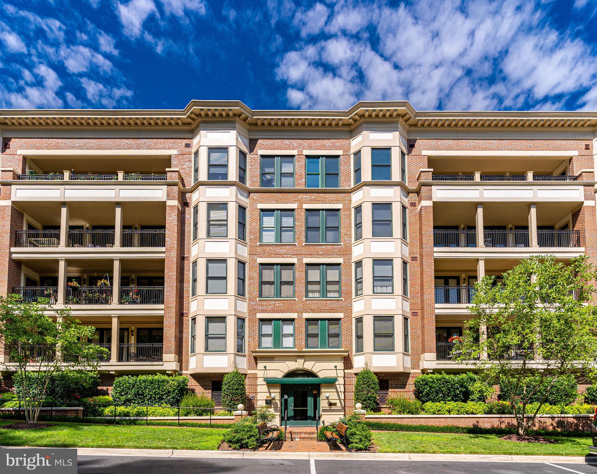 Elegant Strathmore Park condo with 2200 square feet of luxurious one level living only ONE BLOCK to the Grosvenor METRO! This spacious condo is one of only two available with this floorplan and lives like a single family home with a full living room with fireplace and access to balcony, a large 18' X 13' separate dining room and gourmet kitchen with breakfast area open to the family room/den. The two spacious bedrooms are strategically located for maximum privacy and you'll love the two and one half baths and separate laundry room,  High end finishes throughout include wood flooring, crown & chair rail moldings, designer lighting, 9 foot ceilings, custom built-ins and more. Enter through the gracious foyer which includes a formal powder room and flow through the gallery with custom, decorative wood flooring and great walls for art. Continue into the large, freshly painted, living room with gas fireplace, built in wet bar with beverage/wine refrigeration, and access to the sun-filled balcony. Entertain guests in style in the sizable formal dining room with bay window and balcony access. Fit for a chef, the gourmet kitchen enjoys stainless steel appliances, as well as ample counter space and a center island for preparing sumptuous meals.  The Owner s Suite offers access to the private balcony for a morning coffee or late night cocktail.  The primary suite also offers a  spa like bath, separate  linen closet and  large walk-in closet. The second bedroom suite includes a private bath and a walk-in closet with built in shelving. The laundry room offers even more storage plus a laundry sink. This wonderful home conveys with two assigned garage parking spaces (102-A & 102-B) and a separate storage unit (#1). Building amenities include meticulously landscaped grounds, ample guest parking, outdoor pool, and fitness facility located a block away at The Avalon.  Conveniently located just one block to Grosvenor METRO and Strathmore Music Center, easy access to 270 & 495, close to Pike & Rose, Downtown Bethesda, restaurants and shopping. Don't miss this one!