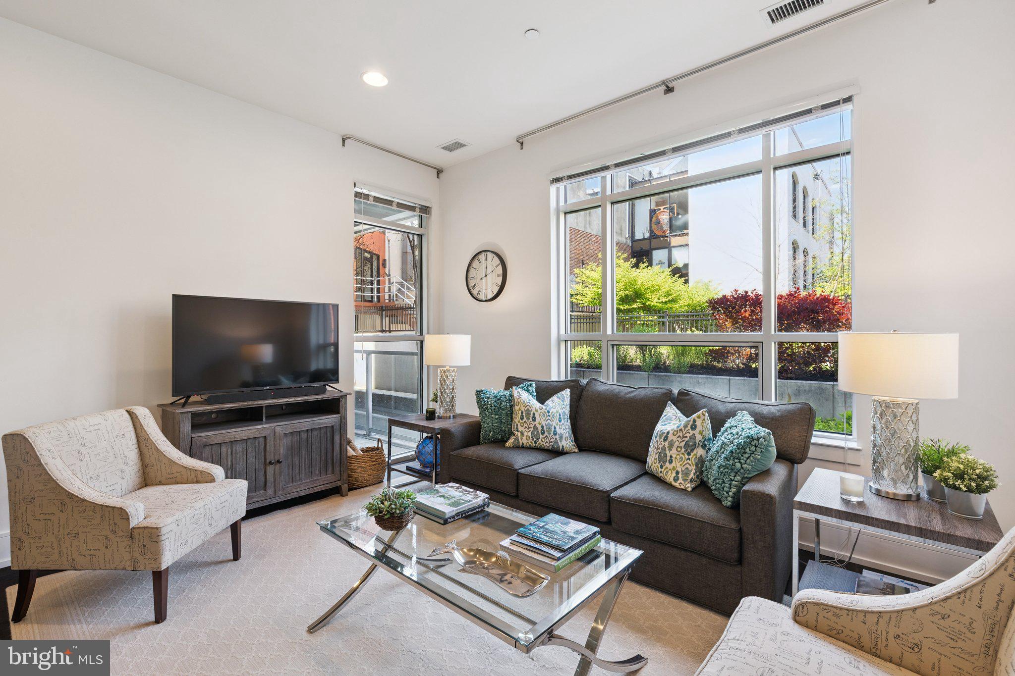 GARAGE PARKING - SOCIETY HILL!
Experience refined city living in this expansive newer-construction one-bedroom residence with a private patio at 410 at Society Hill, offering serene views of the beautifully landscaped community garden and a rare indoor-outdoor lifestyle. Soaring ceilings, wide-plank flooring, and oversized windows fill the home with natural light, while the open living and dining area is perfect for relaxing or entertaining. The sleek chef’s kitchen is outfitted with stainless steel Gaggenau appliances, quartz countertops, modern cabinetry, and a generous breakfast bar. The spacious bedroom suite flows seamlessly to the private patio, perfect for a morning coffee or enjoying the sunset. A custom walk-in closet and a spa-like bath with marble tile, a storage vanity, and a glass-enclosed shower complete the space.  Additional highlights include in-unit Bosch laundry and thoughtfully designed mechanical systems located outside the unit for enhanced comfort and quiet. Residents of this pet-friendly building enjoy full-service amenities including a 24-hour concierge, resident lounge, landscaped courtyard, bicycle storage, and a rooftop deck with sweeping river and city skyline views. Owner's dedicated garage parking space offers direct access into the building - providing unmatched convenience, security, and peace of mind - and is available for an additional $25,000. Ideally located in the heart of Society Hill’s Head House District, just steps from top dining, shopping, Penn’s Landing, parks, and convenient access to I-95.