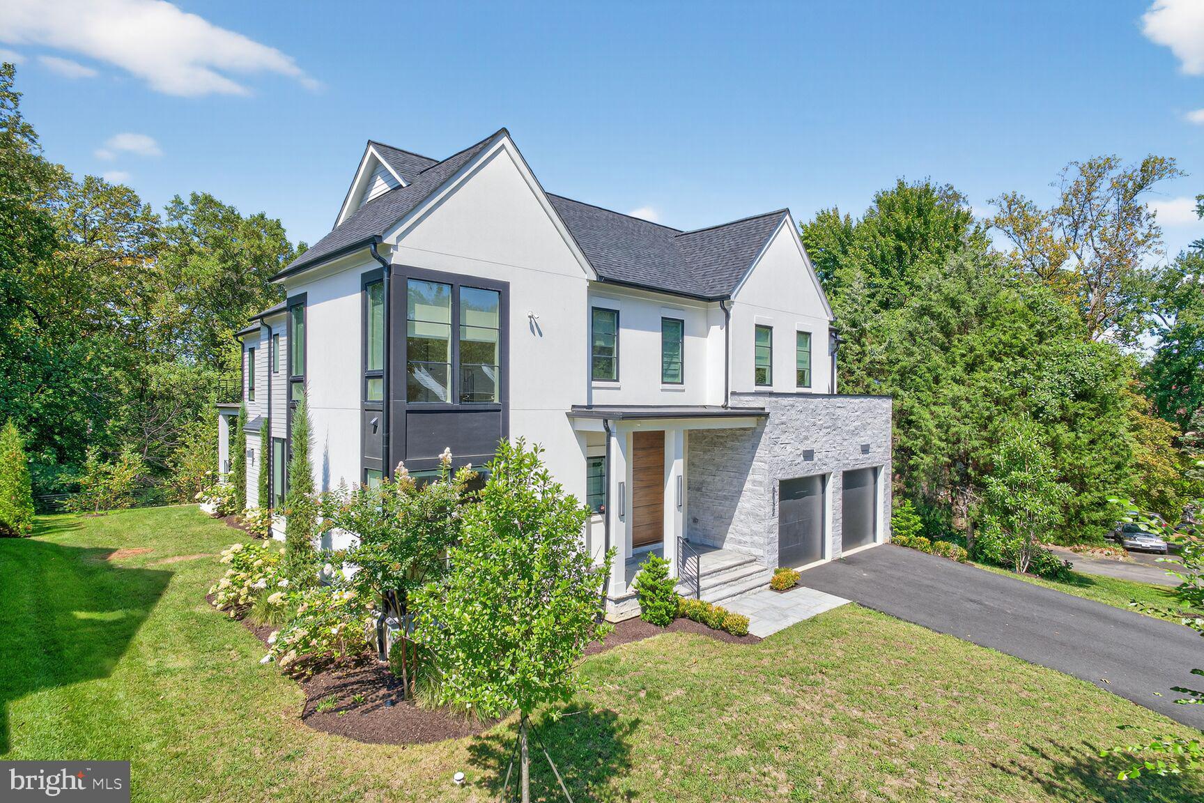 Custom luxury contemporary on a quiet street in highly rated Langley High School pyramid, this McLean gem is within easy walking distance to parks, restaurants and shops. The home features five generously sized bedrooms all with ensuite baths - with the primary suite boasting a private balcony and multiple walk-in closets. The main level open concept includes oversized windows showering light into the kitchen, two dining areas and a spacious family room that flows out to a flagstone terrace overlooking the scenic outdoors. The chef's kitchen is an entertainer's dream with stainless steel Wolf appliances, a 48 inch range, quartz countertops and huge island, beautiful white oak cabinetry, and custom paneled two column Sub-Zero refrigerator. A full size wine refrigerator in the kitchen is complemented by a smaller version in the lower level wet bar/kitchenette that is adjacent to an expansive second family room. The recreation level also walks-out to the yard with its own lawn irrigation system and has its own guest bedroom/in-law/au pair suite and dedicated home gym with pre-padded flooring just waiting for your exercise equipment. Remote and hybrid professionals will enjoy the main level light-filled home office providing the best of both worlds -- easy commuting throughout the DMV (with a Tesla charger in the garage) with the tranquility of a residential neighborhood. With designer lighting, gorgeous fixtures, and a Control4 smart home system, no detail was spared in this magnificent high-end custom home!