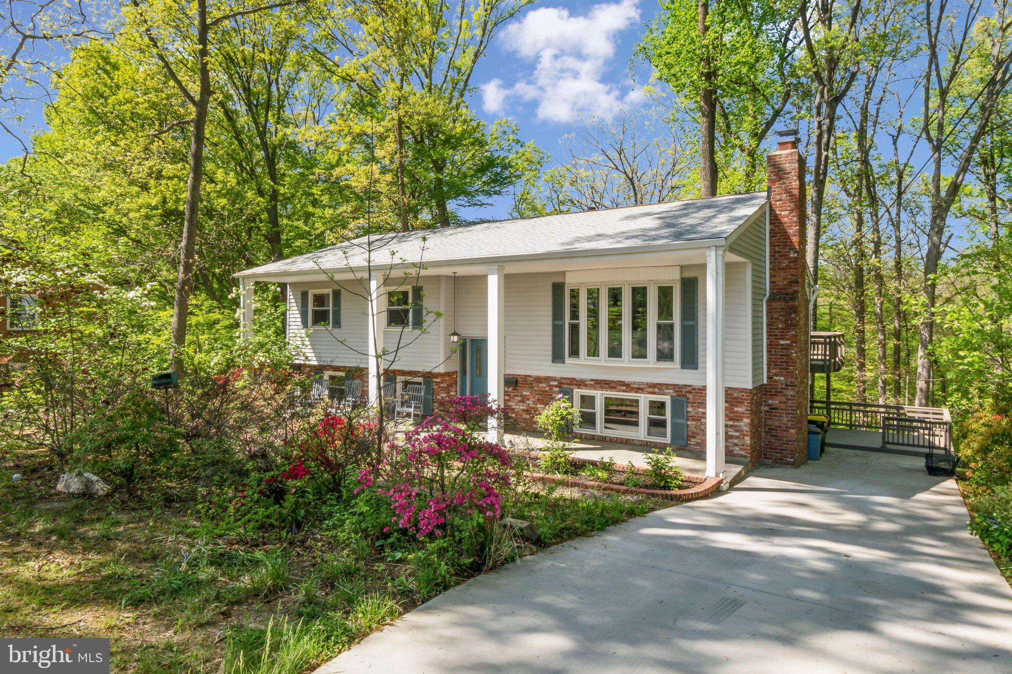 **OPEN HOUSE SATURDAY 4/26 from 1:00PM-3:00PM** 4 bed, 3 full bath single family home sitting on almost half an acre. Fully fenced rear yard with two-tiered deck backing to trees and a creek. Covered front porch with long driveway and ample street parking. Main level has hardwood floors and recessed cans. Kitchen has updated cabinetry, stainless steel appliances, granite countertops, and gas cooking with built-in vent hood. Primary ensuite has three closets, double vanities, built-ins, and overlooks the woods. Renovated hallway bathroom with accent wall and rainfall shower. Lower level is a walkout basement with rec room, 4th bedroom, full bathroom, and two storage rooms. Roof replaced in 2020. HVAC 2019. Water heater 2015. Vinyl windows. Whole house generator. Easy access to commuting routes.