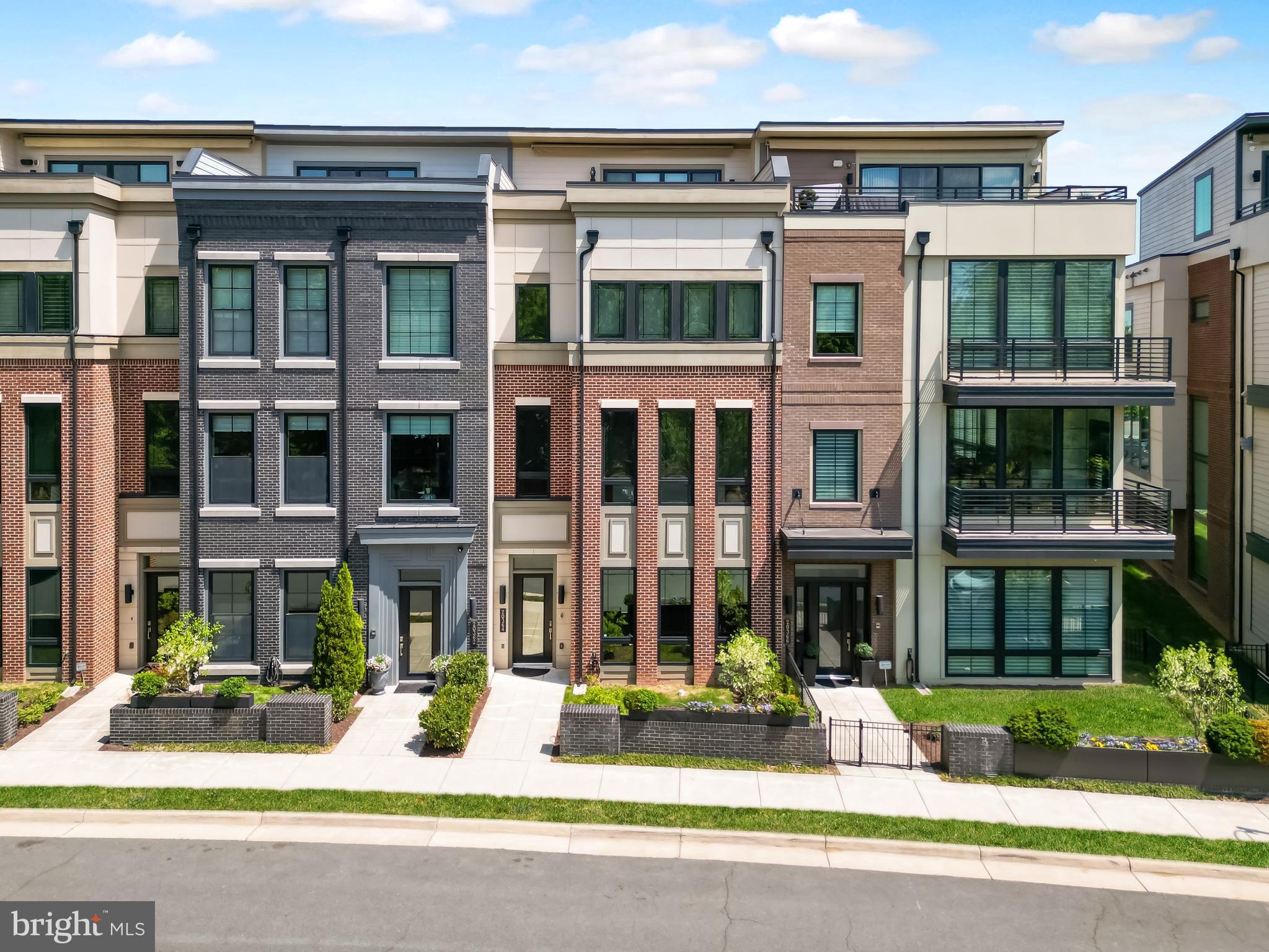 Experience the perfect balance of suburban and urban (Surban) living in the heart of One Loudoun with this unique, park-facing Miller & Smith townhome offering over 4,300 square feet across four impeccably designed levels.  This expansive residence features a private elevator, rooftop terrace, and unobstructed views of the community park, delivering the feel of a luxury single-family home with the convenience of a walkable, vibrant lifestyle. With 5 bedrooms, 4.5 upgraded baths, and multiple flexible living spaces, the home is ideal for multi-generational living, private home offices, fitness areas, or guest accommodations. Furthermore, One Loudoun offers resort like amenities as well as lawn care to bring even more convenience and elevated lifestyle.  

The main living level showcases a sun-drenched open-concept design with soaring 10+ foot ceilings, wide-plank engineered hardwood floors, and seamless flow between the living, dining, and kitchen spaces. The chef’s kitchen is thoughtfully appointed with Wolf Professional appliances, a Sub-Zero refrigerator, quartz countertops, an expansive island perfect for entertaining, and a walk-in pantry with abundant storage. Step out to the private balcony for effortless indoor-outdoor living with gas line ready for grilling.

The third-level has 10 foot ceiling, primary suite that offers tranquil, tree-lined park views and serves as a true retreat, complete with a spa-inspired bath featuring a soaking tub, oversized walk-in shower, and a custom walk-in closet. The hallway bathroom has two vanity with a tub and direct access from one of the two other bedrooms. The laundry room is conveniently located on this level with a linen closet, soaking tub and the washer and dryer that sits on a pedalstool for easy use.

The fourth-level has a bedrooms, a generously sized walk in closet, full bathroom with shower, a loft area that can be used for gym, media, or recreation space that opens to the stunning rooftop terrace perfect for entertaining, grilling, or enjoying sunset views over Central Park.  A powered awning will provide shade in the afternoons.  The terrace also has gas line hookup ready, water hose, outlets ready for fire pit, gardening, and/or wall mounted TV. 

The entry level has 11 foot ceilings, access to front door, garage, mud room, coat closet, and a niche under the stairway for creative functionality. The large versatile room with double glass door is ideal for a bedroom, office, or flex space, along with a full bathroom with a bathtub. The elevator services all four floors. This home is ADA compliant and enhanced with smart home doorbell, door lock, thermostat, security, and whole-home connectivity options. Additional upgrades include Anderson black-framed windows, dual high-efficiency HVAC systems, and premium finishes throughout.

Located just steps from One Loudoun’s renowned dining, shopping, entertainment, and community amenities including parks, trails, clubhouse, pool, and year-round events, this home offers a true live-work-play lifestyle in one of Northern Virginia’s most sought-after communities.