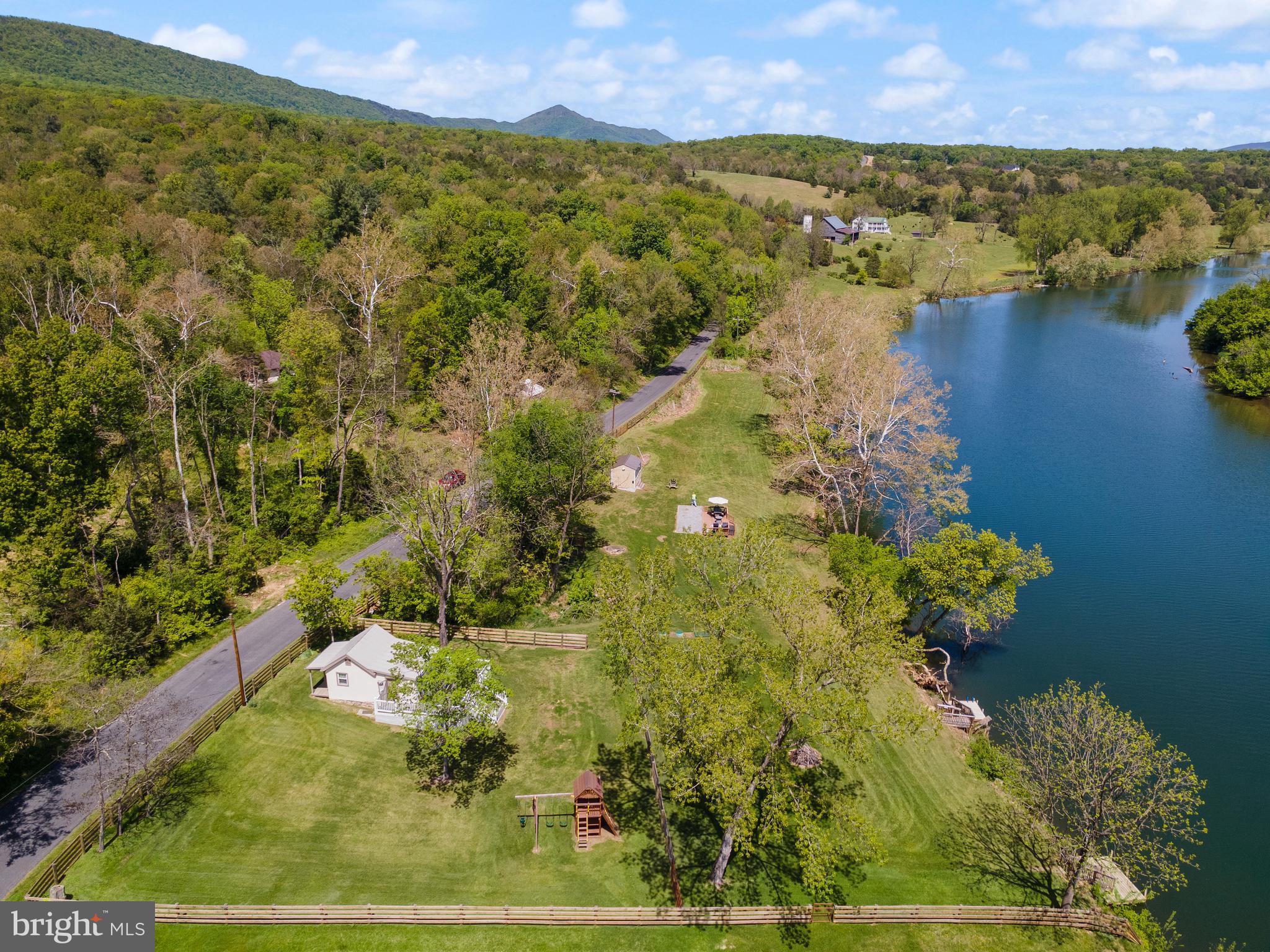 Rare chance to own this gorgeous waterfront property! - Virginia Shenandoah Riverfront — Deep Water, Endless Possibilities- Your Escape Starts at the Water’s Edge. TWO Docks-  TWO properties--TWO acres-(also  included 1438 Egypt Bend)-Own your very own 2-acre, deep water riverfront property! Approx. 550 linear feet of deep-water shoreline! Enjoy endless days of all water sports on this 3-4 mile stretch of deep water above the Luray Potomac Edison Power Dam. Cast a Line, Stay a Lifetime! The property enjoys two small cottages, one recently remodeled. Property being sold with 1438 Egypt Bend Lane. Also includes an RV pad with deck.  Recent upgrades- New Well, septic, new roof, water filtration system, composite deck, 1000 feet of Board fence just to name a few-Septic supports 4 bedroom home.
Wooden playset conveys with furniture and Starlink Satellite Internet System! Located just around the corner from Massanutten Boat Landing for easy boat launching. You can see the Boat landing in the photo. A once in a lifetime opportunity to enjoy deep water riverfront on the South Fork of the Shenandoah! Deep Water Living, Done Right-Call today for more information. Call today for more information to make this yours! The information contained herein is for informational purposes only. Pearson Smith Realty and the listing agent make no representation as to the accuracy or reliability of the information. Buyers should exercise their own due diligence in the investigation of matters related to the property that is material to a Buyers decision to purchase any property listed for sale by Pearson Smith Realty.