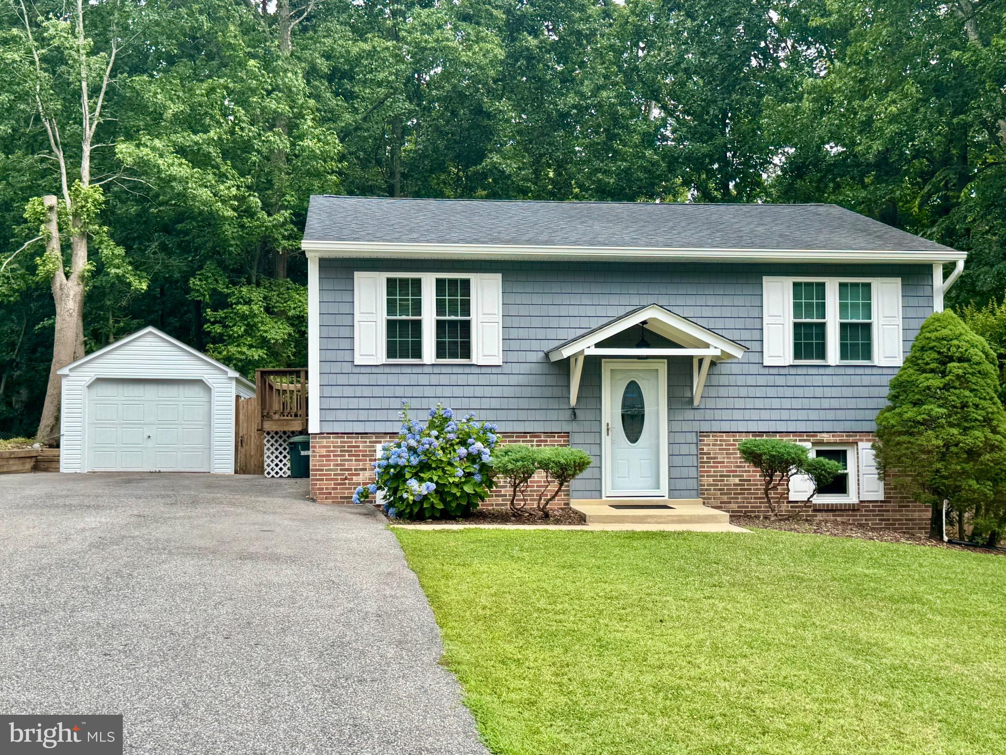 Fabulous opportunity to own this well-maintained 3-bedroom, 2-bath split foyer in the desirable Highlands community of Chesapeake Beach! Situated on one of the best lots in the neighborhood, this home backs to woods and features a large, level backyard fully fenced with a privacy wood fence and rear chain-link fence with gate—perfect for pets, play, and outdoor enjoyment. The updated kitchen offers white cabinetry, stainless steel appliances, LVP flooring, and access to the spacious rear deck overlooking the private backyard. Hardwood flooring extends throughout the living room, hallway, and bedrooms on the upper level. Two bedrooms and a full bath are located upstairs, while the lower level features a large third bedroom, and a second full bath with tiled walk-in shower.  Lower level also has a laundry area with washer and dryer, and a spacious rec room with LVP flooring and newer sliding glass doors leading to the backyard. Additional features include a one-car garage, ample parking, and an unbeatable location within walking distance of the community recreation area that has a playground, basketball court, ball field, and walking/jogging trails. Conveniently located in an area of top-rated schools and just minutes from beaches, marinas, shopping, and restaurants. Easy commute—only approximately 35 minutes to Joint Base Andrews and Washington, D.C.!