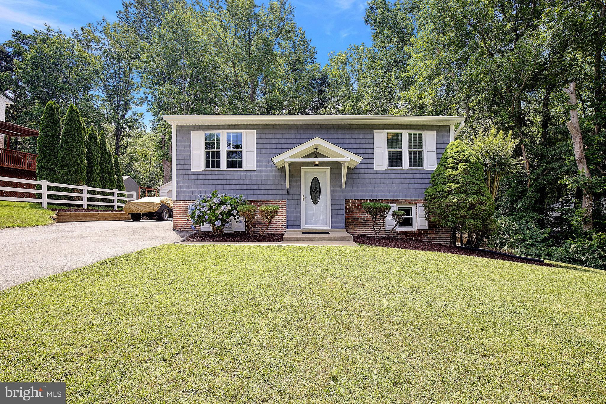 Fabulous opportunity to own this well-maintained 3-bedroom, 2-bath split foyer in the desirable Highlands community of Chesapeake Beach! Situated on one of the best lots in the neighborhood, this home backs to woods and features a large, level backyard fully fenced with a privacy wood fence and rear chain-link fence with gate—perfect for pets, play, and outdoor enjoyment. The updated kitchen offers white cabinetry, stainless steel appliances, LVP flooring, and access to the spacious rear deck overlooking the private backyard. Hardwood flooring extends throughout the living room, hallway, and bedrooms on the upper level. Two bedrooms and a full bath are located upstairs, while the lower level features a large third bedroom, and a second full bath with tiled walk-in shower.  Lower level also has a laundry area with washer and dryer, and a spacious rec room with LVP flooring and newer sliding glass doors leading to the backyard. Additional features include a one-car garage, ample parking, and an unbeatable location within walking distance of the community recreation area that has a playground, basketball court, ball field, and walking/jogging trails. Conveniently located in an area of top-rated schools and just minutes from beaches, marinas, shopping, and restaurants. Easy commute—only approximately 35 minutes to Joint Base Andrews and Washington, D.C.!
