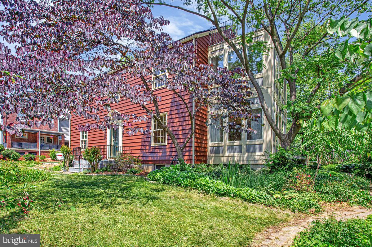 Gracious center-hall colonial, perfectly situated on a large, lush lot in hip, happening historic Hyattsville. Featuring freshly refinished oak floors, high ceilings, and classic architectural details throughout. This expansive property boasts 6+ bedrooms and 7 full baths with over 4300 sq feet of space and beauty.

The  15' x 31'  living room has 3 exposures, 9 foot ceilings, ornamental moldings, and a fireplace with a detailed mantel and wood stove. The main-level bedroom walks-out to the deck and rear yard through new Pella  sliding glass doors and has a classic black/white tile ensuite bath.  The kitchen is the heart of this home with beautiful hickory cabinets, Italian tile, stainless steel appliances, and a center island with a prep sink and gas cooktop, plus two wall ovens. I love the arched spice cabinet- useful and beautiful. The kitchen is open to a vaulted-ceilinged breakfast room with wood beams and arched windows and new Pella SGD doors. There's a beautiful view of the deck and lovely lot from this wonderful kitchen. The 15' x 16' formal dining room has a swing door to the kitchen and off the side is a Dutch door to a kitchenette and full bath with walk-in shower and a separate side entrance - this space can be a 1-BR apartment.

Upstairs the primary bedroom has two walk-in closets, an ensuite bath and pocket doors to a sitting room or a bedroom of its own.  The hall bath is connected to the back corner bedroom which has a big walk-in closet and lovely views of the rear yard.   The front bedroom has a large closet,  and much like the dining room, has a kitchenette and full bath attached and its own exterior entrance - this space can be a 1-BR apartment.

The top floor is a lovely suite. The bedroom has a charming built-in bed with storage and a skylight,  with pocket doors to the spacious dressing room, and shower bath. Plus there's a kitchenette and a family room with built-ins and skylights that opens out to a fabulous roof-top deck with views of the beautiful yard and neighborhood.  There's an exterior spiral staircase for additional egress.   

The basement is super useful and has a family room with the laundry area, plus a full bath used as a dog grooming area for this family.  The basement has a large cedar-lined closet for your winter wear and there's lots of room for storage and to tinker plus there's an exterior staircase that goes to the side yard. 
The property has radiator gas heat and central air, plus mini-splits in the addition - the best of both worlds - and Solar panels are owned outright!
 
This property is able to be configured to have additional separate, income-producing apartments should you desire. 

There's plenty of room to plant and play on this .34 acre landscaped lot. The property backs to MacCaroy Alley and has 2 parking spots on the alley plus a long driveway off Longfellow Street too.  There's a cute and useful shed with a deck - great for garden supplies and bike storage. 

What a beautiful lot with native plantings and a food forest - many edible plants including pecans, figs, blueberries, blackberries, raspberries, service berry, hazelnut, American groundnut, elderberries, and multiple varieties of pawpaws - yum!

Super convenient location near Arts District shops & restaurants. Just over a mile to Hyattsville Crossing Metro Station as well as the Riverdale MARC Commuter rail station ( and farmers market!)  Easy access to parks and the Trolley Trail bike path.  What a great spot to land!