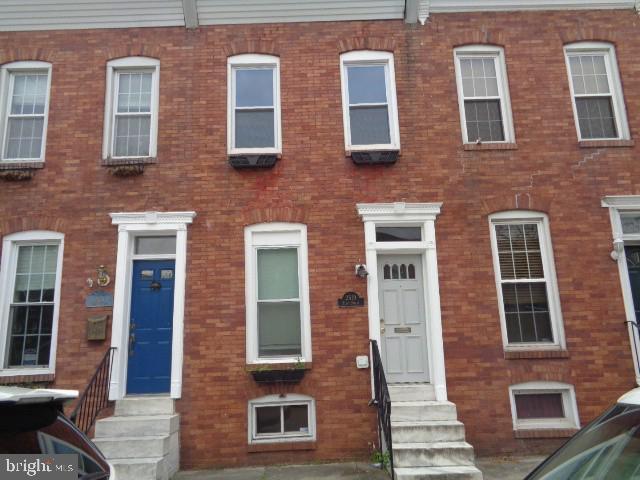 This lovely 2 (possibly 3) bedroom townhouse in Canton offers a large open living and dining area with hardwood floors and exposed brick through out the home.. The 2 large bedrooms on the second floor are carpeted and continue the exposed brick theme. The back bedroom also walks out to the large 2 tier deck with the top leading to the roof. There is a partially finished basement with a full bathroom and area for storage. And for your convenience, there is a parking pad in the back of the home. Fantastic Opportunity!