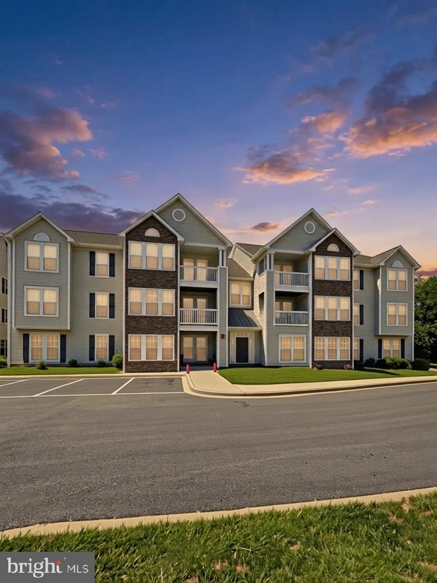Accessible, main-level living in Stuart Mechanic. This comfortable 2-bedroom condo offers true one-level living with no stairs, a ramped building entry, wide interior doorways and a wide hallway for mobility assistance, plus generous circulation space and a spacious main bath designed for easy movement. A wide galley kitchen with ample cabinet and counter space opens to a bright sunroom that leads directly to your own private patio, creating an easy indoor–outdoor flow and a pleasant place to relax. Freshly painted from top to bottom (including ceilings) and finished with all-new carpeting, the home feels clean, bright, and move-in ready. The floor plan includes 2 bedrooms, a private full bath in the primary suite, and a convenient half bath off the hallway for guests, all in a well-kept community close to commuter routes, shopping, and dining—an excellent option for buyers seeking easy living, comfort, and convenience.