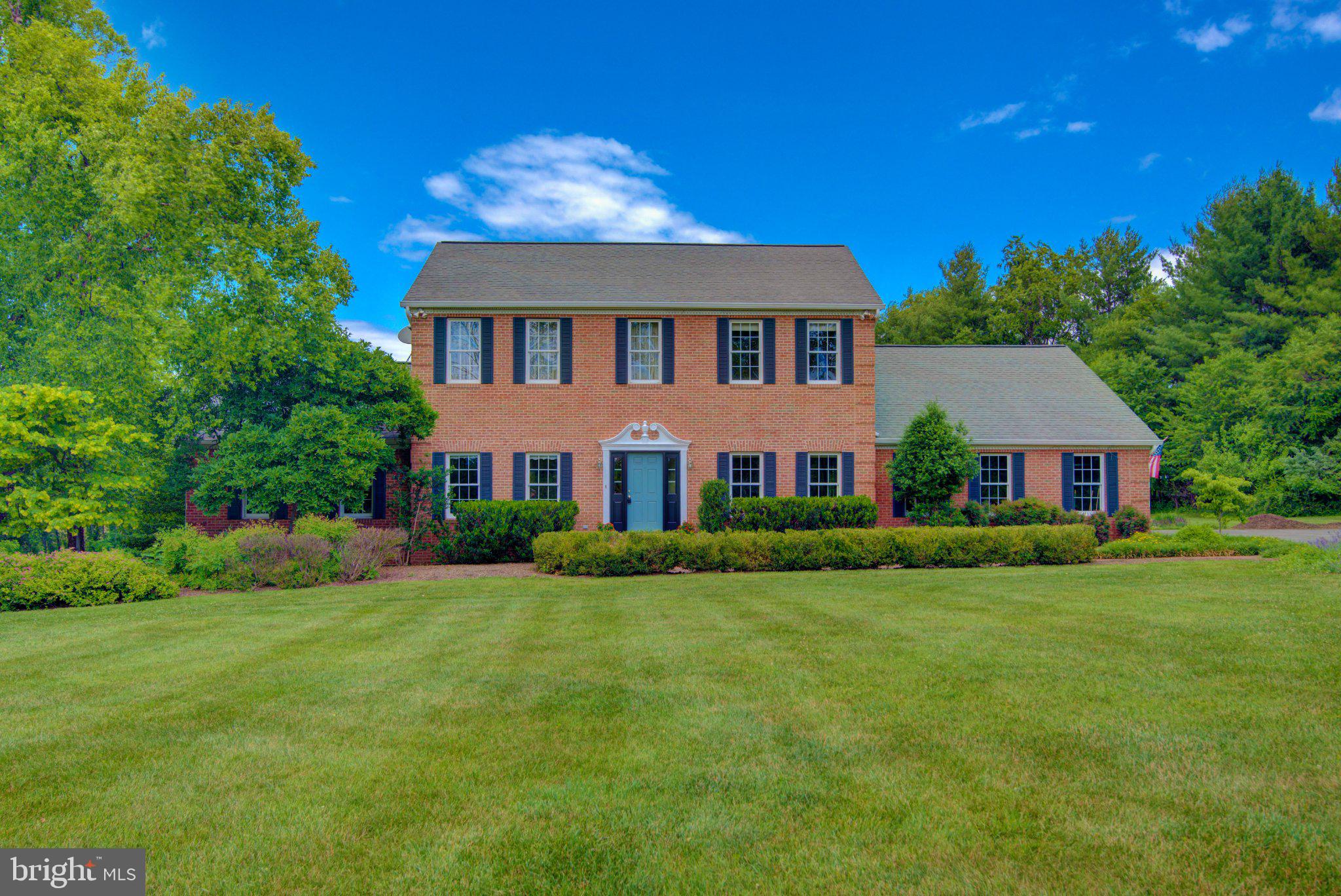 Experience the rare opportunity to own a beautiful home in the heart of historic Waterford, one of Loudoun County's most treasured and picturesque villages. Surrounded by rolling countryside, preserved farmland, and centuries of history, this exceptional property offers the perfect blend of small-town charm, modern comfort, and peaceful country living just minutes from Leesburg and major commuter routes.

Set on a stunning lot with mature trees and expansive green space, this classic brick-front colonial welcomes you with timeless curb appeal and a thoughtfully designed floor plan. The updated kitchen features white cabinetry, stainless steel appliances, generous counter space, and a large center island that serves as the heart of the home. The kitchen flows seamlessly into the breakfast area and spacious family room with fireplace, creating an ideal setting for both everyday living and entertaining.

A highly sought-after main-level primary suite provides convenience and flexibility rarely found in traditional colonial homes. There is second primary suite with large walk-in closet on upper level as well. Every bedroom enjoys its own private en suite bath, offering exceptional comfort and privacy for family members and guests alike. Additional finished living spaces and dedicated home office areas provide room for remote work, hobbies, recreation, and multigenerational living.

The finished lower level expands the home's versatility with recreation and flex spaces ready to adapt to your lifestyle. Outdoors, enjoy an expansive deck overlooking the private, park-like backyard where mature trees and open views create a tranquil retreat perfect for morning coffee, outdoor dining, and evening gatherings.

Located within the National Historic Landmark village of Waterford, residents enjoy a unique sense of community, scenic beauty, walking access to historic sites, annual festivals, and the surrounding wineries, breweries, and outdoor recreation that make western Loudoun County one of Northern Virginia's most desirable destinations.

Best of all, this property offers the freedom and flexibility of country living with no HOA, allowing you to fully enjoy your home and land without additional restrictions or monthly fees.

This is more than a home—it's a lifestyle that combines history, character, privacy, and modern convenience in one of Loudoun County's most iconic settings.