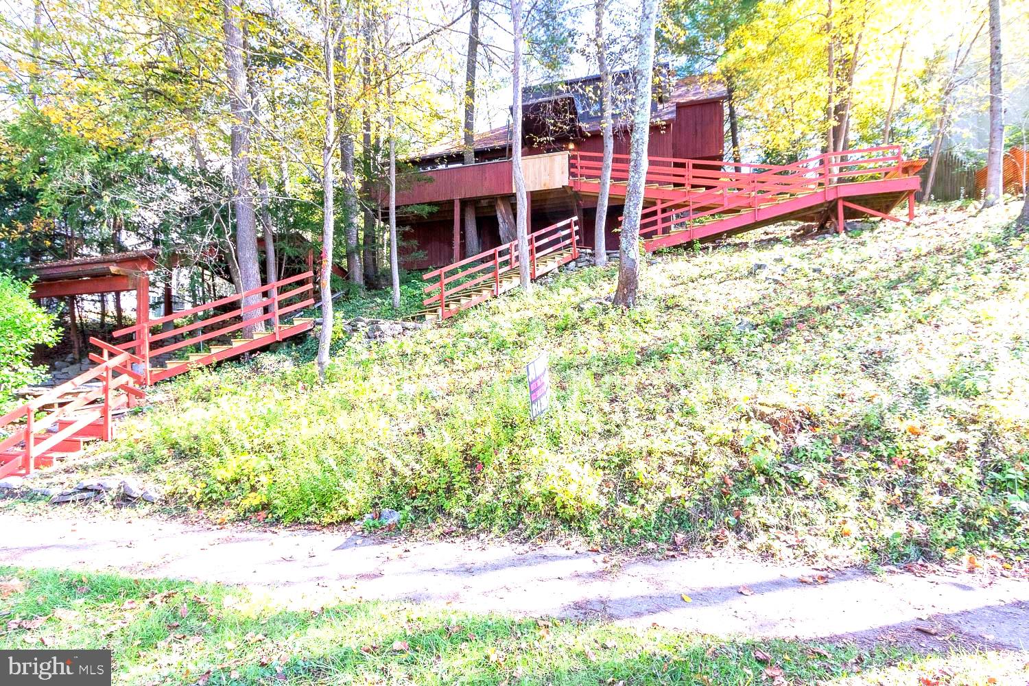 Discover this architecturally designed contemporary home envisioned by renowned architect Josef Van Der Kar that perfectly balances modern living with natural tranquility. This hillside retreat offers 2,009 square feet of thoughtfully crafted space, featuring two bedrooms and two bathrooms in an open floorplan that maximizes both comfort and style.
The heart of this home showcases exceptional craftsmanship, anchored by a stunning stone fireplace that creates the perfect gathering spot for cozy evenings. Large windows throughout flood the interior with natural light while offering serene views of the surrounding trees. The innovative indoor garden brings a touch of nature inside, creating a unique living experience that feels both sophisticated and refreshing.

A charming loft space provides additional flexibility for work, relaxation, or creative pursuits. The outdoor deck extends your living space seamlessly into the peaceful, tree-lined setting where you can unwind and enjoy the quiet hillside location.

Practical comfort meets style with the efficient pellet stove, offering an eco-friendly heating option that adds warmth and ambiance. The College Heights location puts you within walking distance of both town amenities and campus, making daily life convenient whether you're grabbing coffee downtown or heading to class.

This property offers something special for those who appreciate quality design and craftsmanship. The combination of contemporary architecture with natural surroundings creates a retreat-like atmosphere while maintaining easy access to everything State College has to offer. The thoughtful integration of indoor and outdoor spaces, enhanced by mature trees and peaceful surroundings, makes this home a rare find in today's market.