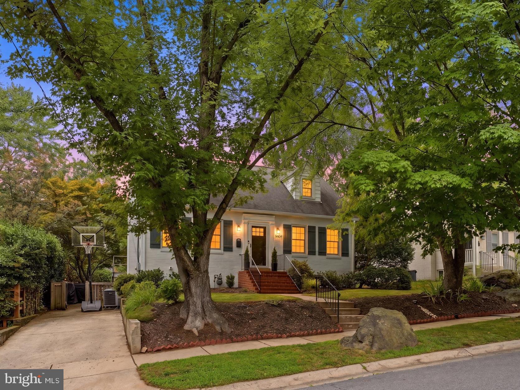 Welcome to 9404 Worth Avenue, a beautifully presented 1936 Cape Cod offering timeless character, flexible living spaces, and an exceptional setting close to Sligo Creek Park and its miles of trails, playgrounds, and recreation.

The main level features warm hardwood floors, graceful arched openings, a bright living room with brick fireplace, a spacious formal dining room, and a well-appointed eat-in kitchen with abundant cabinetry, quartz counters, stainless steel appliances, gas cooking, and direct access to the rear deck. A main-level bedroom and full bath provide valuable flexibility for guests, a home office, or one-level living.

Upstairs, the expansive primary suite includes multiple sitting or dressing areas and a generous walk-in closet. A second upper-level bedroom offers distinctive character and flexible space that could be especially appealing as a child’s or teen’s retreat, with room for sleeping, studying, and relaxing. A second full bath completes the upper level.

The finished lower level adds a large recreation room, a third full bath, laundry area, and an additional finished room that, while not an official bedroom, could work beautifully as a guest room, home office, fitness room, or private flex space. A substantial unfinished storage room provides excellent space for seasonal items, hobbies, a workshop, or household organization.

Comfort and efficiency are enhanced by a two-zone combination boiler and tankless water-heating system installed in 2022, along with high-velocity central air installed in 2017.

Outside, the fully fenced backyard is a true highlight, with mature landscaping, a broad lawn, deck, expansive stone-and-brick patio, multiple seating and dining areas, and a storage shed. The front yard is equally memorable, with mature trees, established landscaping, and dramatic large-scale natural rocks that add wonderful character to the approach. A paved driveway provides off-street parking for one car.

Close to Sligo Creek Park, neighborhood amenities, shopping, dining, and commuter routes, this inviting home offers charm, flexibility, and an outstanding Silver Spring lifestyle.