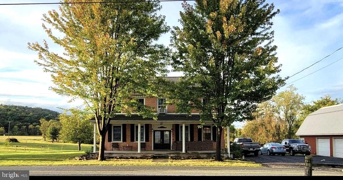 SELLER CONCESSION OF $10,000 towards closing cost or buyer down interest rate!!!
Welcome of this exceptional circa 1856 all-brick farmhouse. Situated on 7.5 scenic acres featuring a tranquil pond and an oversized two-car garage, this 3,406 sq. ft. residence beautifully balances historical preservation with thoughtful modern updates. The property offers a perfect blend of country charm while remaining conveniently located just minutes from historic downtown Gettysburg.

The spacious interior highlights original millwork, pine and chestnut hardwood floors, high ceilings, and a vintage freestanding clawfoot tub. The home includes a remodeled kitchen and a formal dining room that provides ample space for gatherings. Additionally, a functional summer kitchen is ideal for canning and supporting a homegrown lifestyle. The main level also features a large family room with a brick fireplace and a flexible space perfect for an office, study, or additional bedroom and a full bathroom.

The second floor includes a primary bedroom along with three additional bedrooms and two full bathrooms. For extra storage, the home offers a full walk-up attic. The exterior is equally impressive, featuring an inviting front porch, a partially heated 24x36 garage equipped with 100 amp electric, plumbing for water & sewer and an upper level perfect for hobbies or specialized projects.

You can relax and enjoy peaceful views from either the rear patio or the balcony overlooking the pond. The property has been meticulously maintained, please reference the attached detailed list of recent updates and renovations. Seller just installed new septic pump with 3 year warranty 5/26