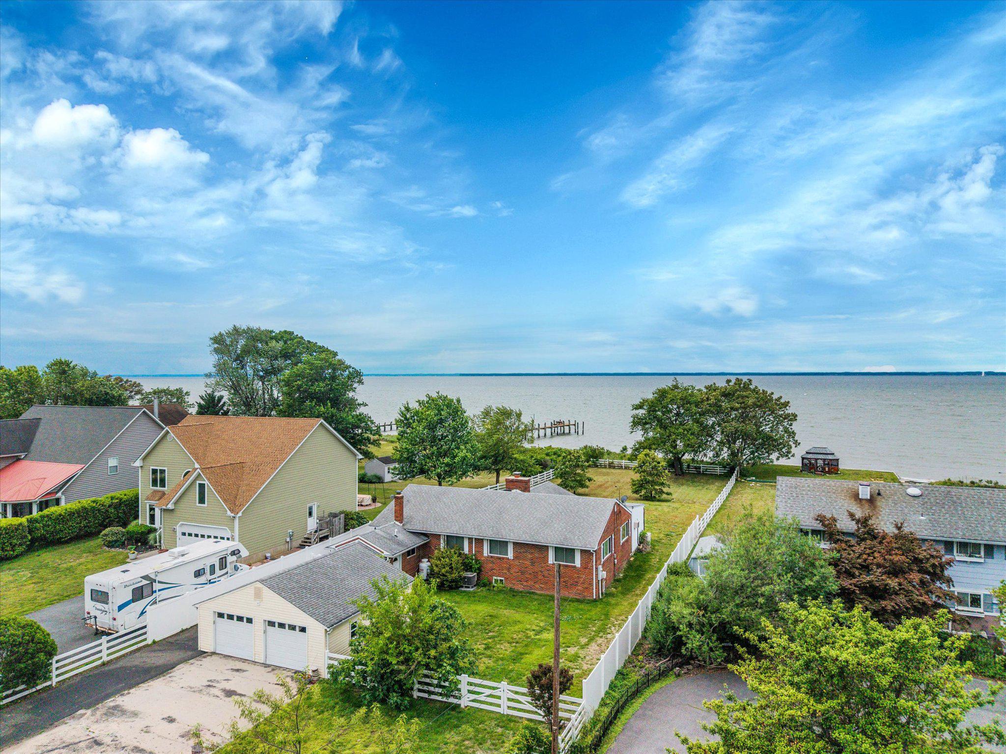 COMING SOON!  Wonderful opportunity awaits on the sandy beaches of the Chesapeake Bay.  Bring your vision and dreams to this three-bedroom rancher in need of major updates located on the southern shores of Kent Island.  This home is ready for your vision of a salty life on the Bay. Conveniently located about 15 minutes from the Bay Bridge in the popular neighborhood of Tower Gardens.  The expansive lot provides ample room for possible renovation and expansion of the home's current footprint.  Sandy beach area with plenty of room for installation of a private pier or use the community's private boat ramp.  Attached 2 car garage with large parking pads.  Fenced in yard for privacy.   Public Sewer installed in 2022 allows for the immediate addition of bedrooms and bathrooms for the new owners. Home is ready for quick settlement and investors are welcome! Expected on Market June 23, 2026.