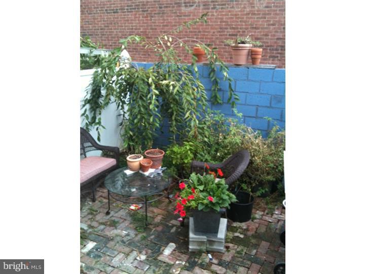Attention all artists looking for a live/work space. Huge 2400 square foot 3 story corner brick property in Old Kensington is for sale. This home is quite large with windows along the entire East side and original Hardwood Floors throughout. Enter in through a vestibule entrance. There is a formal finished parlor/sitting room. The remaining foot print for the 1st floor is a huge studio work space. In essence 3/4 of the 1st floor is an unfinished open layout perfect for an artist, woodworker, etc. The first floor has a full bath and there is access to a brick rear patio. The 2nd floor is the main living area. There is a living/dining room and open kitchen with exposed brick,  stainless refrigerator and gas stove. The 2nd full bath is located in the hall and there is 1 bedroom in the front of the house. The 3rd floor has 2 bedrooms with a large walk in closet. The rear bedroom has a small roof top deck. Huge unfinished basement. All mechanics were updated in 2008.