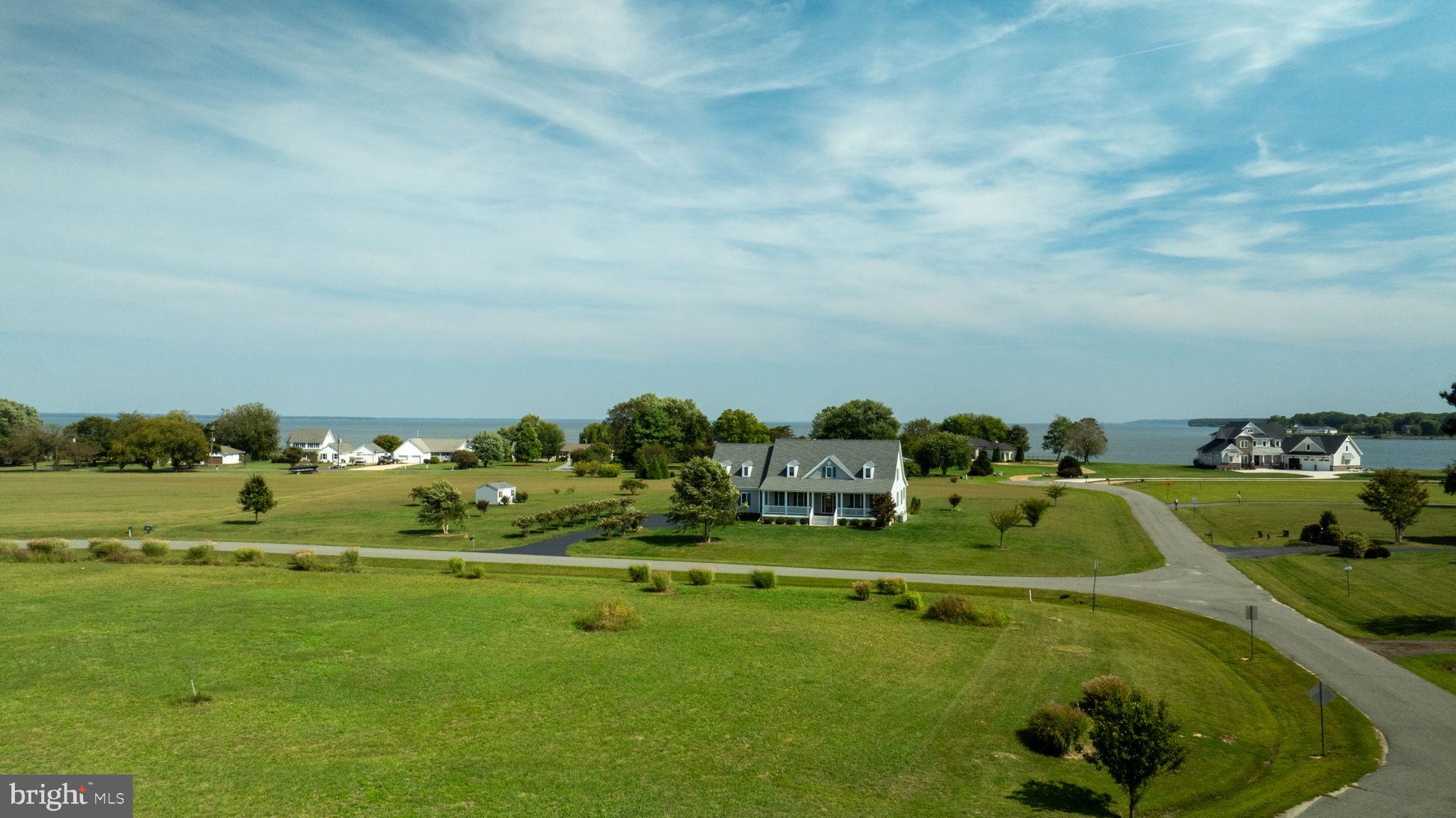 This is one beautiful building Lot! Unobstructed water views will surround your future home without the hassle of regulations, the expense of erosion, and the added responsibilities that come with waterfront lots. This 6-acre lot is level, cleared, and lovingly maintained, situated in a golf cart community with multi-million-dollar homes, and is free from an HOA. Electric, water, and sewer hookups are readily available and conveniently located nearby. To drive by this beauty is to fall in love!