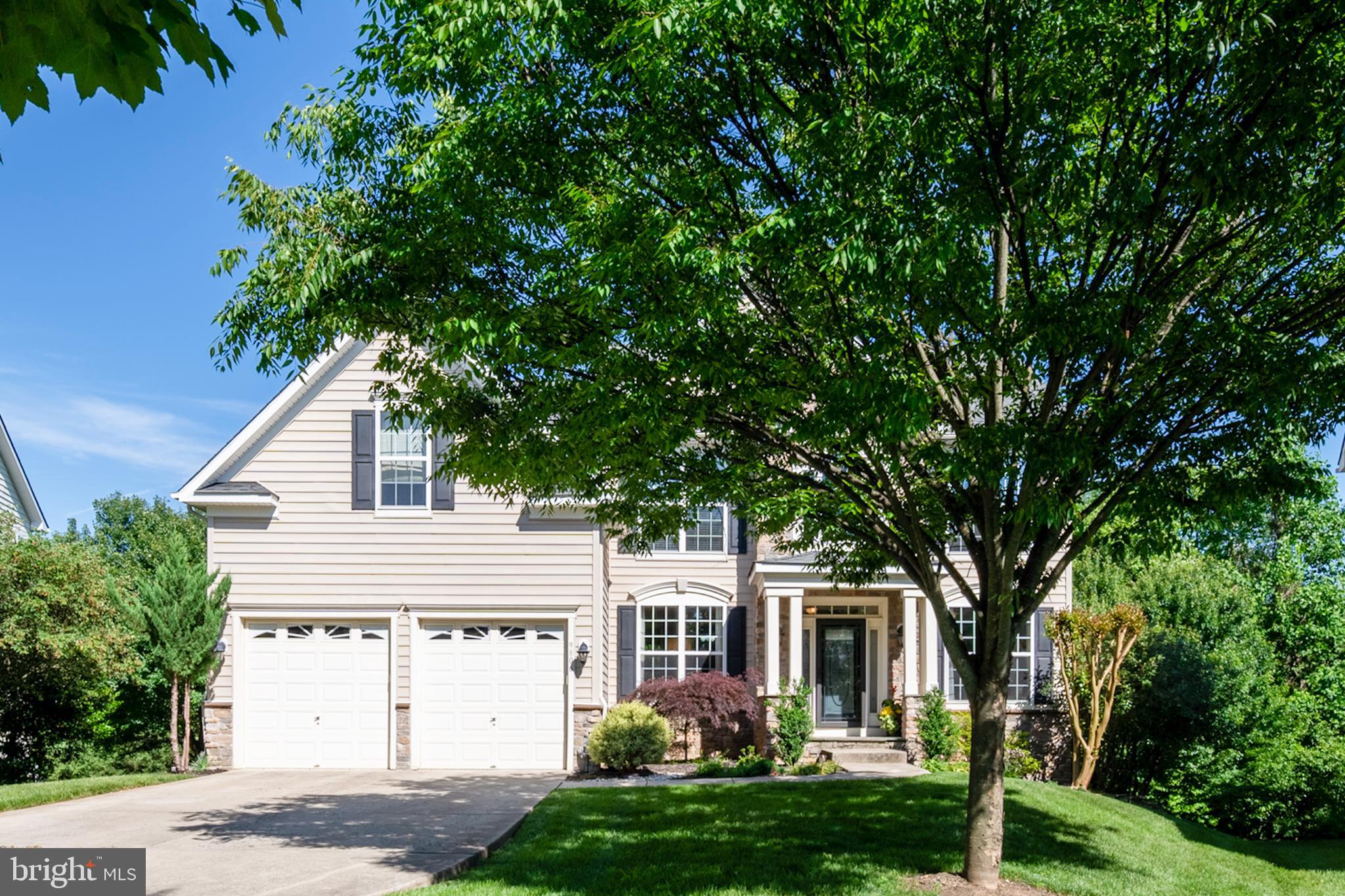 Welcome to this spectacular 6-bedroom, 4.5-bathroom Colonial in the coveted Emerson community, offering over 4,200 sq. ft. of luxurious living space across three finished levels! From the moment you arrive, the stunning stone and wide-plank siding exterior, charming dormers, and welcoming covered front portico make a lasting first impression.  Step inside the grand two-story foyer, where gleaming hardwood floors, architectural columns, crown molding, and an abundance of natural light set the tone for the entire home. The open-concept main level is ideal for everyday living and entertaining, featuring formal living and dining rooms with elegant accent molding, a dedicated home office, a convenient powder room, and a laundry room.  The gourmet chef's kitchen is a showstopper — boasting 42-inch cabinetry, granite countertops, a large center island with pendant lights, stainless steel appliances, and a breakfast nook. The kitchen flows seamlessly into the warm and inviting family room, highlighted by a stunning floor-to-ceiling stone fireplace, and out to the expansive deck with a peaceful, tree-lined view — perfect for outdoor dining and entertaining.  Retreat upstairs to the oversized primary suite featuring a tray ceiling, a sitting area, his-and-her walk-in closets, and a spa-inspired en suite bath with a jetted soaking tub, separate shower, and dual vanities. Four additional generously sized bedrooms with spacious closets and two full bathrooms complete the upper level.  The fully finished lower level offers incredible versatility with a fifth bedroom, full bath, recreation room, exercise space, and abundant storage — plus a walkout to the backyard.  Located on a quiet cul-de-sac in the heart of Emerson, residents enjoy access to scenic walking trails, tennis and basketball courts, tot lots, and a recently renovated clubhouse with a community pool. Conveniently situated between Baltimore and Washington D.C. with easy access to major commuter routes, top-rated Howard County schools, and a wealth of shopping, dining, and entertainment options.
This is the one — don't miss it!