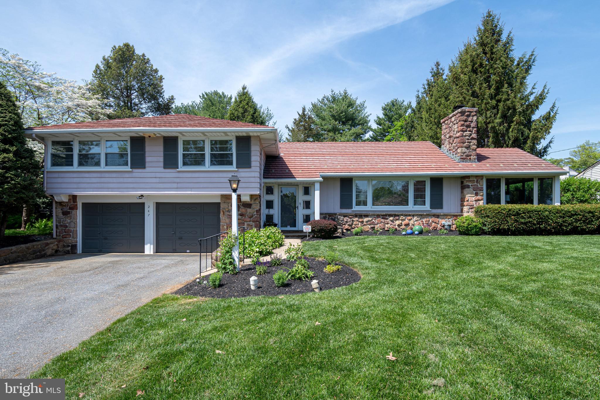 Nestled in the heart of Manheim Township, this classic Murry Hill Drive home perfectly balances comfort, character, and everyday functionality. From the moment you step through the front door, you’re welcomed by a charming stone foyer, original hardwood floors, and a beautiful stone wood-burning fireplace — all flooded with natural light from the home’s many oversized windows. The main floor offers a spacious living room with a large picture window, a stone and wood-paneled accent wall with built-in shelving, and a bright, inviting dining room accented with crown molding and chair-rail details. Off the dining room, the sunroom blends original stonework with warm wood paneling, creating the perfect spot to unwind. The lower level offers direct access to the garage, a half bath, laundry area, and a versatile bonus room — ideal for a playroom, office, family room, or guest bedroom. Upstairs, you’ll find a primary suite with a private full bath and ample closet space, along with two additional generously sized bedrooms and a second full bathroom. Step outside and enjoy summer evenings in the private, level, fully fenced backyard. Located just minutes from downtown Lancaster, major highways, shopping, and dining, this location can’t be beat.