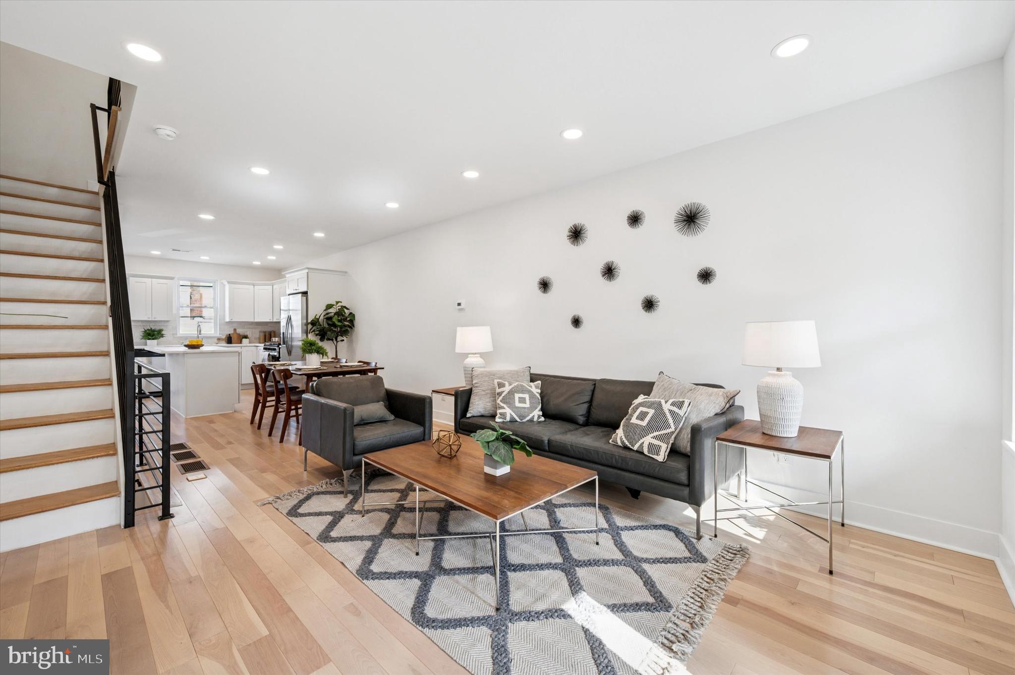 Welcome to 1432 S Newkirk Street- a beautifully remodeled 2-story property on a 14x48 lot in vibrant Grays Ferry!  The remodel of this two-story home (which included a rear addition) was just completed in 2025 and features a thoughtfully designed interior that maximizes space and light. Enter into the property via its front porch on Newkirk Street and you'll find an open floor plan that seamlessly connects the living, dining, and kitchen area, creating an inviting atmosphere perfect for entertaining or relaxing. Beautiful hardwood floors flow throughout, enhancing the warmth of the home. The modern kitchen is the highlight of this home, with plenty of storage and an island. It features white Shaker cabinetry, stainless steel appliances, and quartz countertops.  In the basement, you'll find an open finished space and utilities and laundry in a separate room in the rear. On the second floor are two generous bedrooms and two full bathrooms. This is a perfect opportunity for an investor or end user to have a top quality home, close to shopping, major highways, and more, in growing Grays Ferry.
