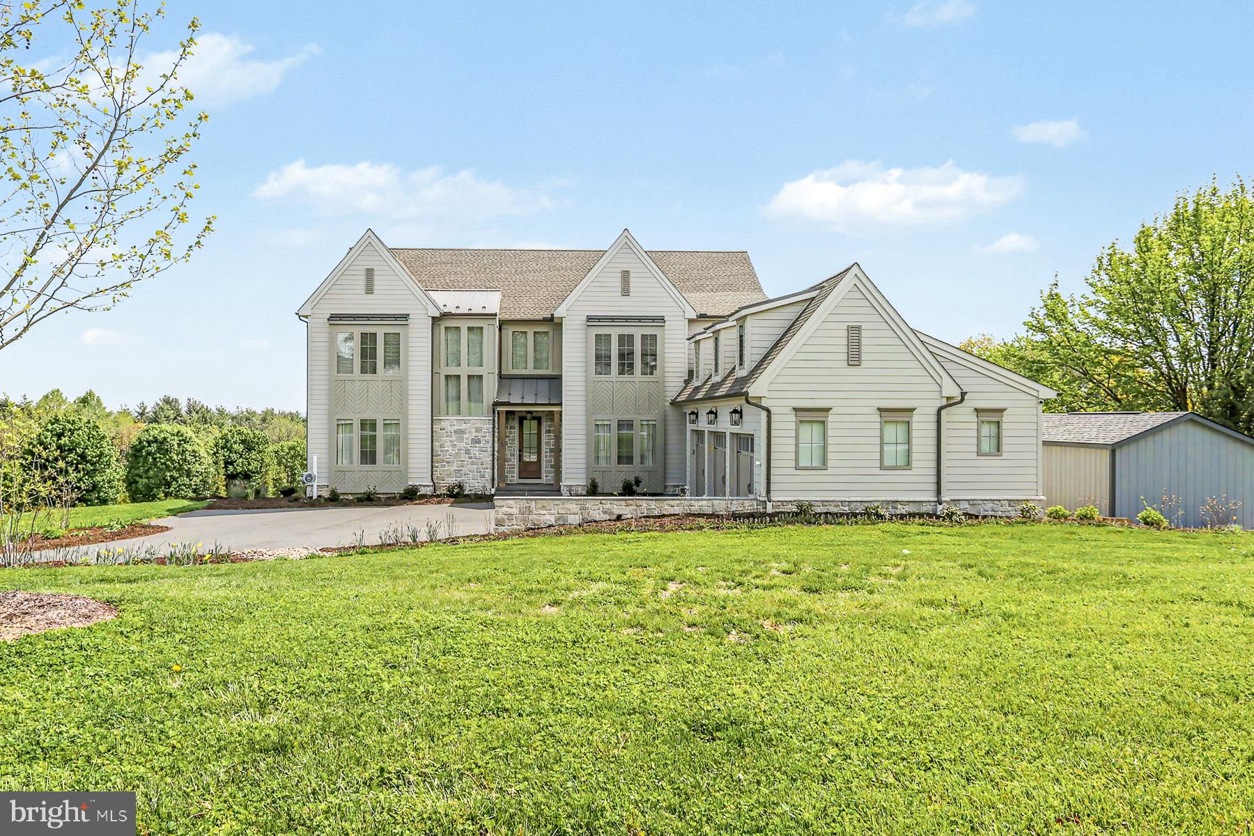 Welcome to 1 Strawberry Lane — a custom-built estate by Pine Hill Building Co., gracefully set on 1.08 acres and thoughtfully crafted for elevated living. At the heart of the home, a stunning chef’s kitchen showcases dual quartz islands, premium GE Café appliances, a hidden scullery, and an expansive walk-in pantry designed for effortless entertaining. Soaring 10’ ceilings, a dramatic two-story foyer, and a striking dual-sided fireplace create an atmosphere that feels both warm and sophisticated, while the primary suite delivers a true spa-inspired retreat with a freestanding soaking tub, rainfall shower, and designer tile finishes.

Beyond the beautiful interiors lies a truly remarkable foundation — a high-performance mechanical backbone featuring Lennox HVAC, a Navien tankless hot water system, and advanced PeakFlow water treatment and UV reverse osmosis, all designed to provide exceptional efficiency, comfort, and peace of mind. The bright walk-out lower level offers endless future potential, while a designer paver patio beneath the covered Trex deck extends living outdoors at its finest. The thoughtfully curated landscape includes 50 newly planted arborvitae for privacy, along with a flourishing blackberry garden and a vibrant pollinator garden featuring over 30 varieties of perennials, and also a dedicated workshop shed for added versatility. Simply stunning! Schedule your private tour today.