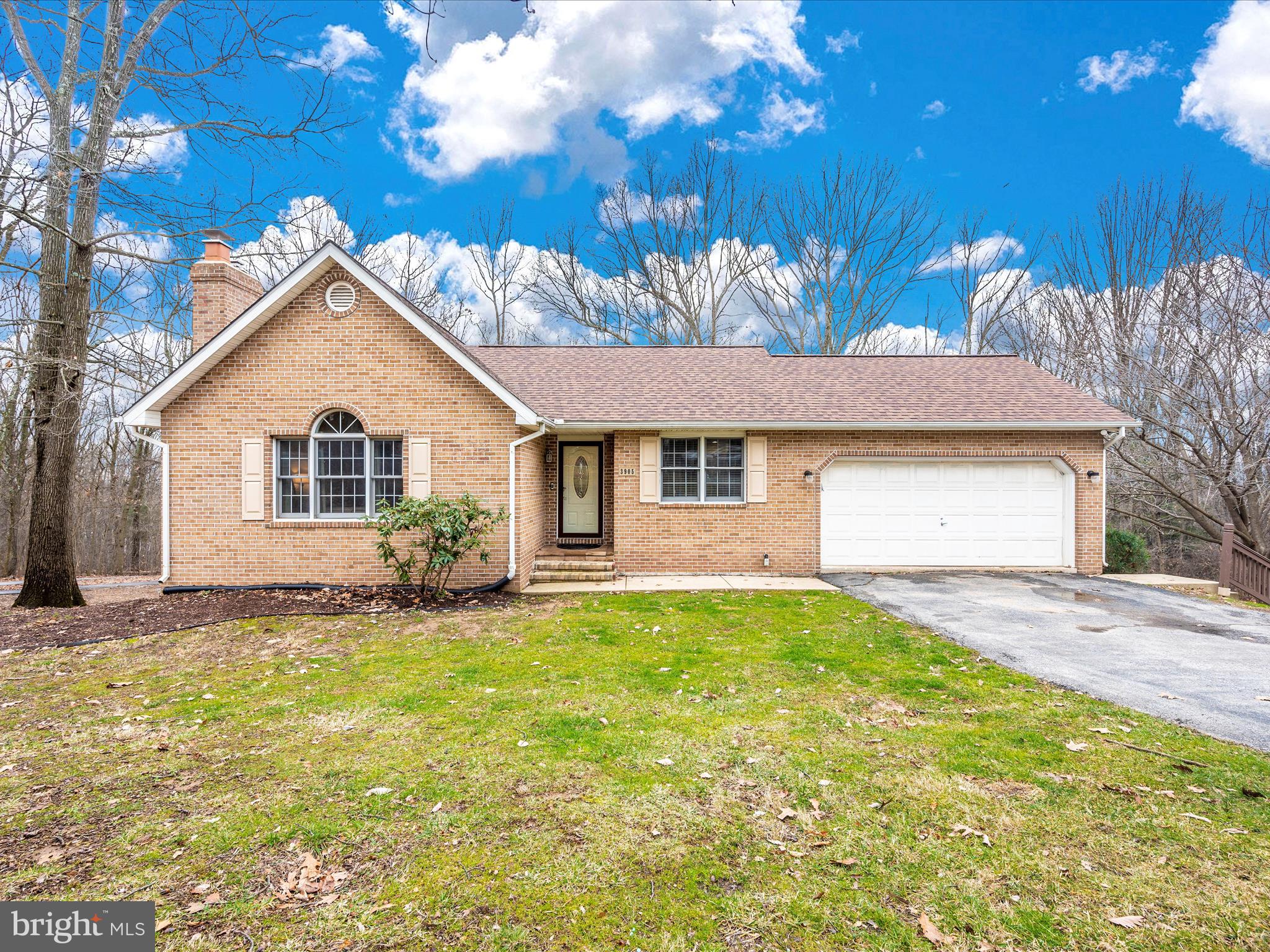 This stunning brick rambler nestled on a private 1 acre wooded lot has undergone a major transformation! As you enter, your eyes will be drawn to the brand new kitchen that was completely renovated and expanded to create the ideal space for culinary enthusiasts. Featuring a large 8 foot center island with seating for 4, upgraded soft-close cabinetry, upgraded granite countertops, custom backsplash, stainless steel appliances, recessed lighting, beautiful new flooring, custom paint and complementary lighting fixtures are the cherry on top. From the kitchen, step outside to your large deck for additional dining, grilling, and entertaining space and take in views of your large private backyard. The cozy family room is open to the kitchen and features vaulted ceilings and a wood burning fireplace for the ultimate space to gather. Down the hallway, you'll find two generously sized secondary bedrooms and a hall bathroom. At the end of the hallway you'll find the primary suite which is more like a private oasis featuring vaulted ceilings, a primary bathroom with a double bowl vanity, as well as an atrium door giving you access to your deck, perfect for enjoying your morning coffee while taking in the sights. The lower level features a bright full daylight walk out basement with access to your patio, a 3rd full bathroom, a kitchenette with space for additional dining and entertaining, an office, and a cozy secondary family room and ample storage space. As if this home couldn't be any better, it also features a new roof (2022), New radon system (2022), new carpet in bedrooms (2022), New water pressure tank (2022), new indoor HVAC unit (2022), new hot water heater (2024), new washing machine (2023), new flooring on upper levels and secondary family room in lower level, and new custom paint throughout the entire home. This is a quality home that has been lovingly brought to life by the current owners, and now its ready for you to call "Home"!