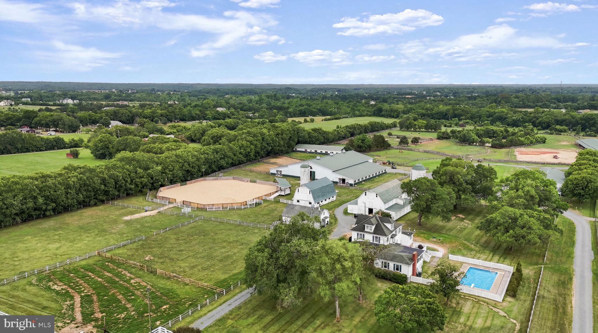 Mulberry Farm: 57-Stall Premier Equine Facility with 1912 Estate Home

Mulberry Farm is a turn-key equine estate configured for professional training, boarding & large-scale events. An established venue for cutting, barrel racing, English lessons & clinics, the property combines a natural pond & pastures with premium, multi-barn infrastructure totaling 57 stalls. Built for operational efficiency, dedicated paths connect all buildings, keeping horse movement separate from vehicle areas.

The training & event infrastructure features 2 main arenas & extensive overnight amenities. The 140'x80' indoor arena building integrates 30 center-aisle stalls along its sides (13 stalls on one side, 17 on the other) over durable concrete floors. Stalls measure 12'x12' (except two 12'x24' foaling stalls) & include individual lighting & fans. Stall lights & fans on the 17-stall side were replaced in 2026; those on the 13-stall side are under 4 years old. This building also features an oversized tack room, full kitchen, concrete wash stalls with hot water & an upstairs spectator lounge. This facility operates on its own independent electric meter, with water from a dedicated 350-ft well maintaining consistent pressure at 48 ft.

Supplementing the indoor space is a 140'x140' outdoor event arena with exterior lighting, an elevated judges' stand, a 10'x40' spectator platform & 20 dedicated RV hookups. Positioned adjacent to the outdoor arena, the 2-story, 25'x40' "Hen House" has its own dedicated electric meter, offering a premier setup for event-day concessions, a tack shop or vendor retail. A dedicated exterior wash station is located at the outdoor arena for immediate cooling.

Specialized stabling & outbuildings offer extensive infrastructure for diverse operations. A renovated original barn adds 10 center-aisle 12'x12' stalls & 10 exterior 10'x10' stalls, complemented by an adjacent detached 2-car garage. For breeding or rehab, a separate 60'x108' barn houses 7 oversized specialty stalls (one 12'x24', two 24'x36' & four 24'x24'). A 30'x50' original Dairy Barn provides substantial storage or event venue potential. Flowing out from the facilities, turnout infrastructure includes multiple paddocks across the property, with rear paddocks featuring 2 functional run-in sheds & an automatic waterer.

The main house, built in 1912, offers 4,500 total sq ft of living space (3,500 sq ft above grade) & operates on an all-electric system with 2 panels shared between the house & original barn. Water for both is supplied by the primary house well, serviced by a shared, dedicated UV water filtration system. A new 5-bedroom perc septic system was installed May 2026. Climate control is managed by 3 HVAC units (one replaced 2025, two are 15 years old & regularly serviced) & the roof is approx 15 years old.

The home's main level includes a primary bedroom with full bath, formal living, dining, family room with brick fireplace, sunroom, kitchen & an oversized mudroom remodeled in 2023 with a half bath. The upper level provides 4 additional bedrooms & 2 full baths (1 en-suite), plus a finished attic with HVAC. Outside, a composite deck leads to an operational 20'x40' concrete in-ground pool with a diving board & all components working.

The property has a tenant (Prestige Training, utilizing the equestrian facilities only) who wishes to remain. Unrivaled potential to scale operations into a premier mid-Atlantic equestrian hub by expanding the competition calendar, establishing high-volume summer clinics or increasing boarding capacity across multiple specialized disciplines.
