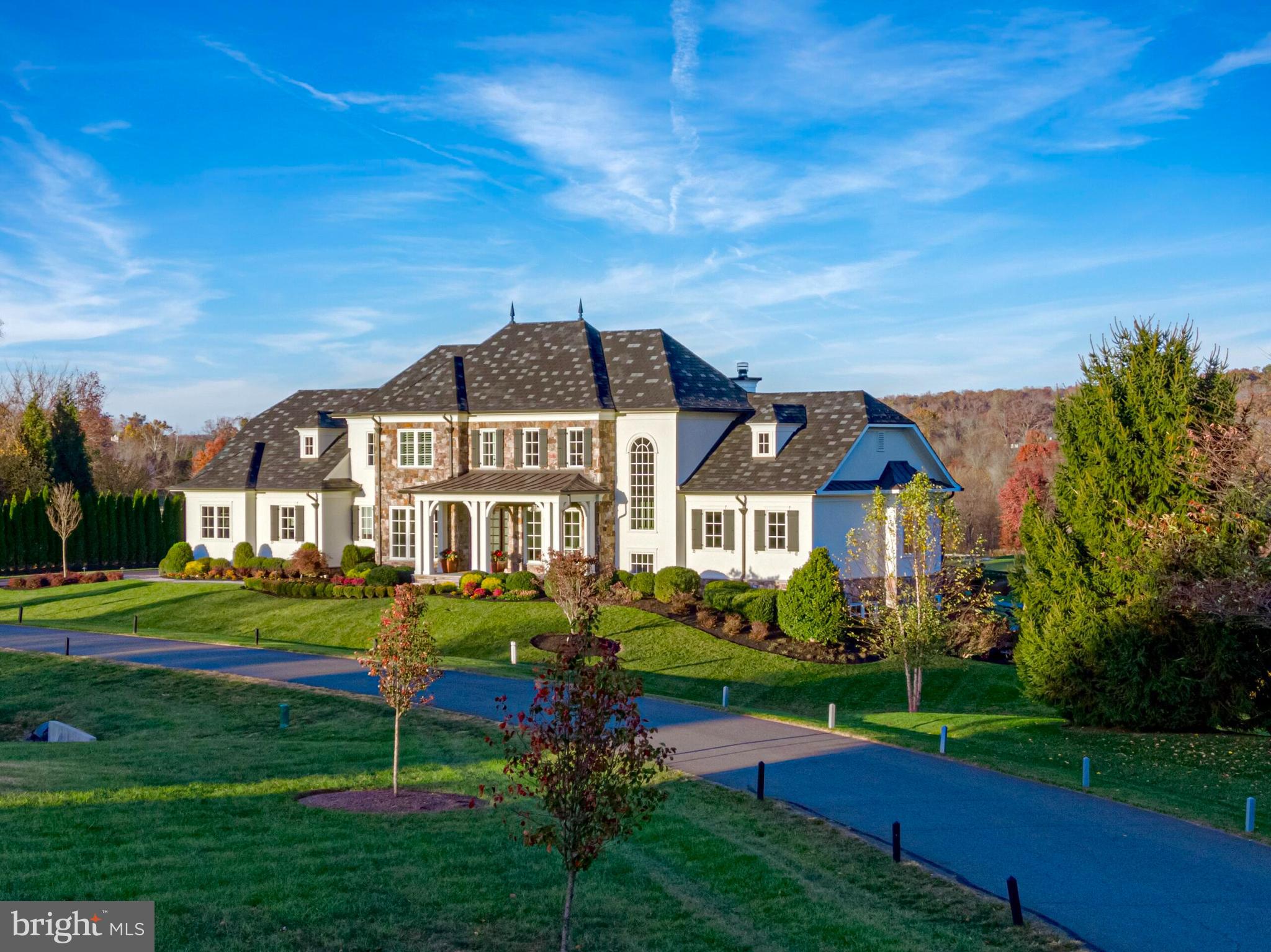 Behind the gates of the highly esteemed Creighton Farms Club community - where luxury and resort-style amenities meet nature. This stunning home has undergone a whole house renovation, resulting in a luxurious and visually striking masterpiece. Situated with spectacular views of the Creighton Farms golf course and surrounding rolling hills, a short stroll will lead you to all Creighton amenities such as golf, tennis, pickleball, pools, workout facilities, fine dining, and events. This remarkable property boasts a French style exterior, combining the timeless elegance of stone with the charm of traditional lathe stucco. Step inside and be captivated by the seamless integration of indoor and outdoor living spaces, offering close to 11,000 square feet for both large-scale entertainment and private serenity. The open floor plan creates an inviting atmosphere, highlighted by soaring ceilings and beautiful walls of windows that flood the space with natural light. The interior features five spacious bedrooms and five and a half bathrooms, providing ample room for family and guests. The dark hardwood floors, stained in place, exude sophistication throughout the entire home. The state-of-the-art kitchen is a chef's dream, boasting a six-person seating area, Subzero refrigerators, separate freezer drawers, Wolf cooking appliances, and Miele dishwashers. Indulge in panoramic views of the front and back yards from the extensive raised masonry patio, where you can unwind and enjoy the serene surroundings. The grand fireplace adds a touch of elegance, while the additional flagstone hardscape provides the perfect spot to appreciate a soothing water feature. The walkout, light-filled lower level of the home embodies modern luxury, featuring a quartz waterfall bar and a vertical wall of quartz that serves as a striking focal point. Stay active and fit in the private workout room or gather with friends and family in the custom-designed theater, perfect for entertaining and creating lasting memories. The bathrooms in this home are true spa-like retreats, complete with modern fixtures, high-end materials, and a timeless design. Designer light fixtures, ample recessed and cabinet lighting, and a new whole-house Kohler propane generator add the perfect finishing touches to this delightful home. This home also boasts low-maintenance features such as public water and sewer, as well as a 22-zone irrigation system that draws from a community well. 
Don't miss the opportunity to own this exquisite property in the prestigious Creighton Farms community. With its unparalleled beauty, impeccable craftsmanship, and top-of-the-line amenities, this home is truly a dream come true. Schedule your private showing today and experience the epitome of luxury living!  
Nestled within the greater Washington DC area, Creighton Farms stands as a pinnacle of exclusivity among private club communities. Its crown jewel, the illustrious 18-hole Jack Nicklaus championship golf course, sets the stage for an unparalleled experience. Prepare to indulge in a resort-style paradise with an array of amenities at your fingertips. Immerse yourself in the state-of-the-art golf facility boasting heated indoor bays, two Har-Tru and two USTA hard-surface tennis courts, and three new pickleball courts. Unleash your potential at the fitness and wellness facilities or bask in the sun-drenched bliss of the resort-style pools. The elegant Club House offers a sanctuary for indoor and al-fresco dining, complemented by the convenience of overnight club rooms for members and guests. Exclusive, multi million-dollar improvements are coming to the elegant Club House, including fresh new dining options both indoor and al-fresco and an updated Golf Shop. Additional tennis courts are also planned. Embark on a lifestyle of extraordinary distinction at Creighton Farms and immerse yourself in a world of unparalleled luxury.