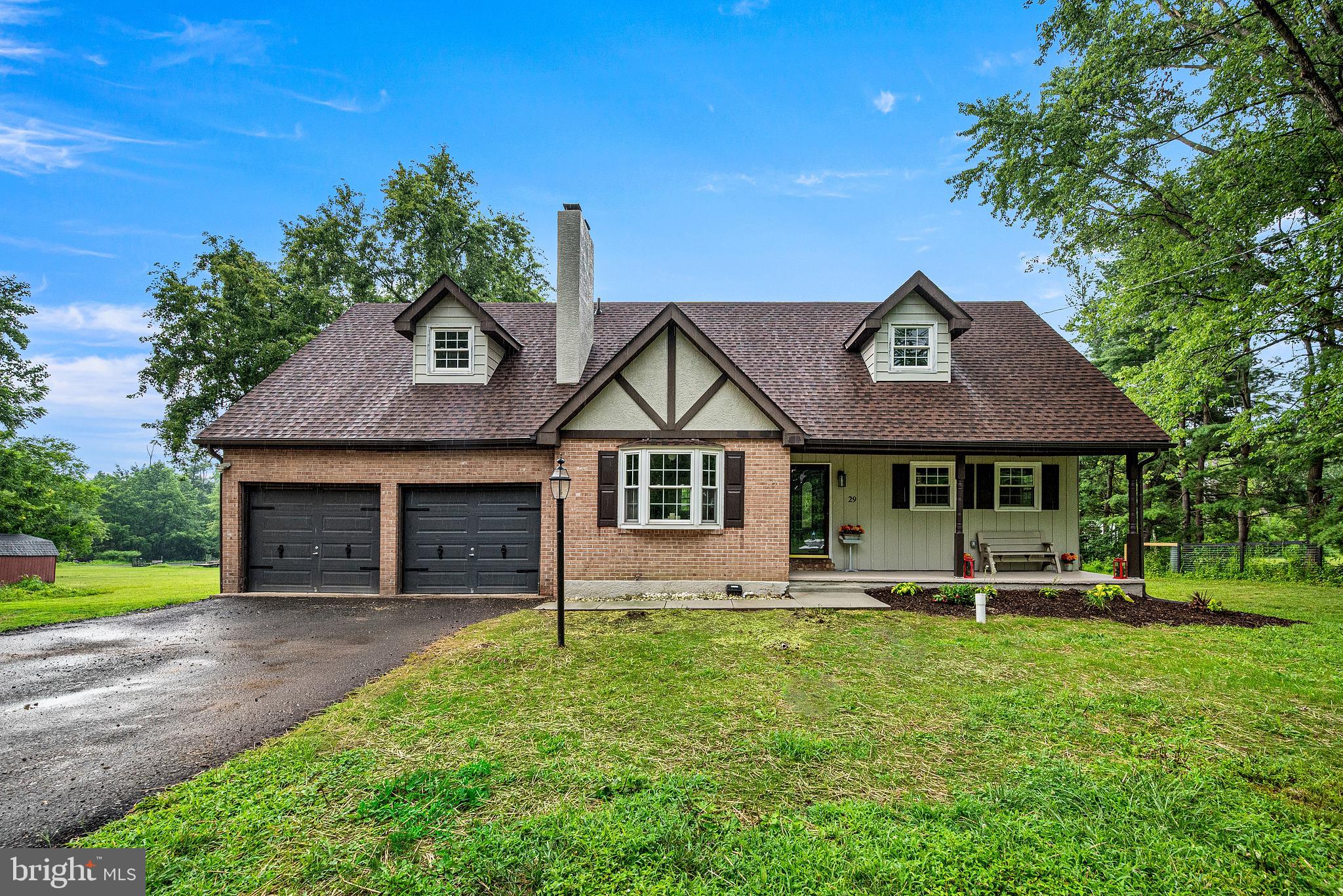 ORDINARY ENDS HERE...EXTRAORDINARY BEGINS THE MOMENT YOU TURN INTO THE DRIVEWAY. Some homes are beautifully renovated. Others are truly ONE-OF-A-KIND. Nestled on nearly 2 PRIVATE, LEVEL ACRES in highly sought-after Limerick Township, this beautifully reimagined property offers a rare combination of location, privacy, and craftsmanship. Imagine ending each day overlooking mature trees and a neighboring organic farm while remaining just minutes from shopping, dining, Route 422, and the award-winning Spring-Ford School District. This is the lifestyle estate buyers wait years to find.

Completely reimagined from top to bottom, this home delivers the PEACE OF MIND every buyer deserves. Nearly every major system has been replaced, including TWO BRAND NEW heat pump HVAC systems, new 200-amp electrical service and panel, all new plumbing, a brand-new sand mound septic system, new well pump, new 50-gallon water heater, several new windows, fresh paint, new flooring throughout, and all required permits professionally pulled and approved. Private utilities help reduce long-term ownership costs, while recessed lighting with dimmer switches throughout adds a modern touch.

At the heart of the home is a breathtaking OPEN CONCEPT kitchen designed to bring people together. Designer-curated Brown Fantasy natural stone countertops, a custom backsplash, soft-close cabinetry, brand-new stainless steel appliances, elegant pendant lighting, and a beverage center create a space equally suited for everyday living and entertaining. The adjoining living room is anchored by a beautifully cleaned and serviced WOOD-BURNING FIREPLACE, while the formal dining room with a striking matte black chandelier is ready for holidays and celebrations. A beautifully updated powder room and versatile first-floor bedroom—perfect as a guest suite, office, or playroom—complete the main level.

Upstairs you'll find THREE SPACIOUS BEDROOMS, highlighted by an impressive primary suite with two oversized closets and room for a king-sized bedroom set. The spa-inspired ensuite features an oversized tiled shower, luxury MULTI-JET SHOWER PANEL SYSTEM, LED mirror, and designer finishes. The second full bath has also been beautifully remodeled with its own multi-jet shower panel system and custom tile. Two additional spacious bedrooms and TWO IMMENSE HALLWAY CLOSETS provide the storage today's buyers are searching for.

THINK YOU'VE SEEN IT ALL? THINK AGAIN. The finished walkout basement adds another level of living with a spacious recreation room, bar area, pellet stove, and direct backyard access. Just inside the oversized two-car garage you'll find a mudroom with soaring ceilings, laundry hookups, and exceptional storage. Need even more space? A large outdoor shed with a new roof offers abundant room for lawn equipment and seasonal storage. Step outside to discover what truly sets this property apart. A freshly stained multi-level deck overlooks nearly two acres of flat, usable land framed by mature trees and peaceful views of the neighboring organic farm. The oversized two-car garage with high-bay workshop area, covered front porch, and driveway accommodating up to eight vehicles make this property as practical as it is impressive.

PRIVATE. PEACEFUL. TURNKEY. Opportunities like this rarely come along. Finding nearly two level acres in Limerick Township with LOW LOW TAXES, Spring-Ford Schools, complete privacy, and a home renovated to this level is exceptionally rare. If you've been waiting for a property that truly stands apart from everything else on the market...your search ends here. Welcome home. 
OPEN HOUSE SUNDAY JULY 26 FROM 12PM-2PM!