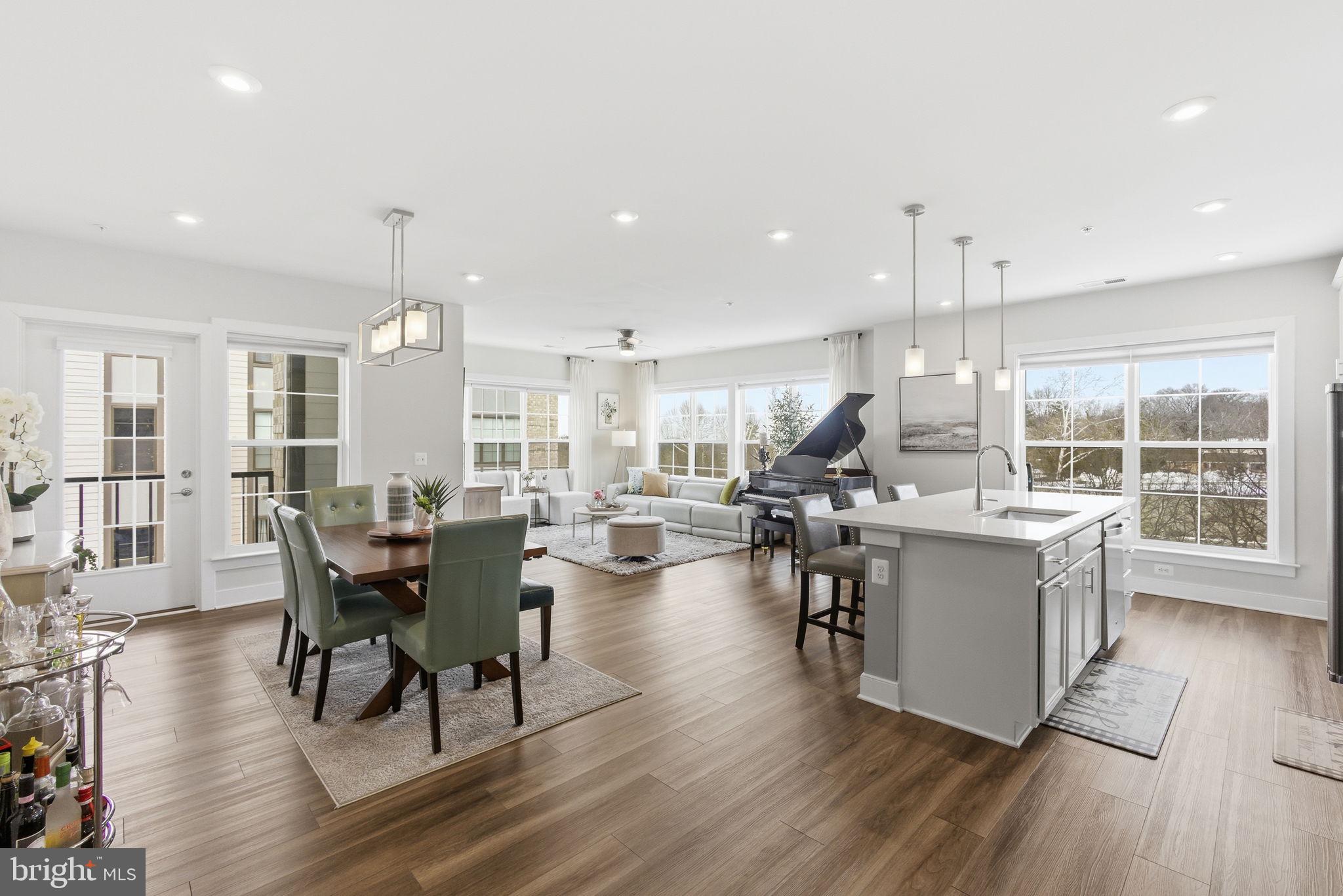 JUST REDUCED!!! MOTIVATED SELLERS!!!! Welcome to one of the fabulous and meticulously maintained end unit condominium in the most popular National Harbor - a tourist haven ideally located in the waterfront within the boundaries of Maryland, Virginia, and Washington, DC. This condominium, which is only two years old, is a representation of the owner's love for elegance, timeless beauty, and superior regards for cleanliness and hygiene.  Their love for their abode is reflected on how they care for the property making sure that it is regularly kept neatly and orderly.
Prospective occupants of this property will definitely be pleased and happy when they take ownership of this unit.  It has been properly and precisely maintained, making you feel that you're taking possession of a newly constructed residence.
As soon as you set foot on the foyer, you will be amazed with the high- end looking luxury vinyl plank flooring which spreads to the open concept layout.  The end unit location of the condo allows for all around windows fitted with blinds, capturing three sides of scenic views of the vibrant community.  The seamless flow of the receiving area is architecturally designed with a beautiful kitchen equipped with stainless steel kitchen appliances, quartz countertop, spotless backsplash, 42- inch cabinets with upscale cabinet handles and accessories.  The cooktop is enhanced with commercial type range hood also in stainless steel.  The wall oven with microwave completes the kitchen ensemble.  The kitchen island with sink serves as an eat-in counter as well and can accommodate up to five bar stools/chairs.  The unique pendant lights hanging on the kitchen island provide ample brightness. Both the dining and living room areas are enhanced with luxurious chandeliers which contribute to the brilliance provided by the recessed lights on the ceiling.  You will be amazed with the vastness of the primary bedroom which has an en-suite bathroom with stand-up shower, a luxurious vanity with double sink, and a huge walk-in closet.  The second bedroom which can serve as a guest room, is ideally located on the other side of the unit providing privacy to the occupant while enjoying the serene and beautiful views from the windows.  Both bedrooms have affluent carpeted flooring.  A second full bathroom with soaking tub is conveniently positioned adjacent to the bedroom and the laundry room.  Springtime season is almost in the horizon - relax and enjoy the balcony overlooking the stream of similarly beautiful condominium complex and the panoramic views of Washington DC and Oxon Hill.  
Enjoy life peacefully and confidently while you're here. - your privacy is secured by utmost security policy - nobody can infiltrate your residence without granted permission from the homeowner.
Take delight and pleasure on everything that National Harbor has to offer; MGM Hotel and casino, restaurants, Gaylord National Resort and Hotel, Tanger Outlets, scenic Potomac River trails, etc... close to Oxon Cove Park & Hill Farm which provide enjoyment activities the whole year round like playing with farm animals and concelebrate with their yearly fall festival.  Accessible to Routes 95, 495 and 295.  Minutes to Alexandria, Virginia, and Washington, District of Columbia. MOTIVATED SELLERS!!!!!