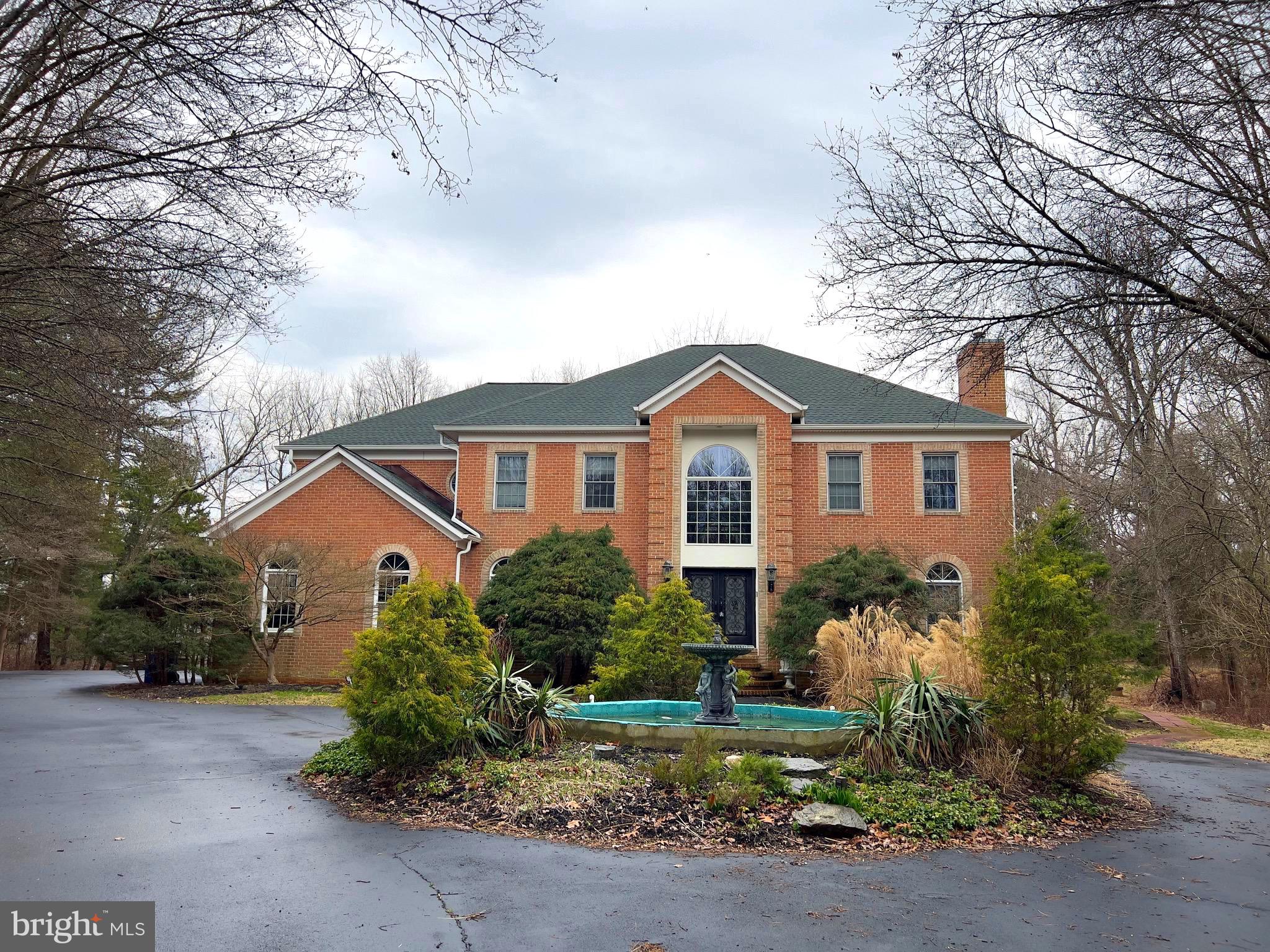 *** EXCEPTIONAL CUSTOM-BUILT HOME *** Nestled in a serene, park-like setting, less than 2.5 miles from Great Falls Village, this one-of-a-kind, custom-built, all-brick home offers an exceptional value for the discerning buyer. Situated on 2 acres, this residence boasts a myriad of features both inside and out.

As you approach the home, a circular driveway with a charming fountain welcomes you to the large double-door entrance. Stepping into the double-story, marble-floored foyer, you are greeted with abundant natural light. To one side, the formal living room beckons with its beautiful fireplace, while the spacious dining room on the other side invites you and your guests to enjoy culinary delights.

Past the gracefully curved staircase, the sun-drenched, two-story family room awaits with its expansive Palladium-style windows and a three-way fireplace, enticing you to relax. 

Adjacent to the family room, a generous library/office with custom-built bookshelves offers a quiet retreat, while a guest powder room provides convenience. The large breakfast area and open, spacious gourmet kitchen are perfect for entertaining family and guests alike.

Venture outside onto the expansive custom-built steel and Trex deck, offering views of the sprawling backyard encompassing almost an acre. The custom-built Solarium echoes with the melodies of exotic birds and provides a sanctuary for Peacocks in their caged houses.

Exploring further, two additional levels await your discovery. Ascend the newly stained staircase for a breathtaking top-to-bottom view of the grand entrance and family room. The spacious primary bedroom beckons with a sitting area, roomy walk-in closet, and a large bathroom featuring a tub, separate shower, and double vanities. A light-filled second bedroom with a full bathroom, along with two more generous bedrooms sharing a full bathroom, complete the upper level.

Descend the stairs to the lower level, where your senses are treated to an extraordinary experience. The theater/media room, furnished with reclining sofas and chairs, invites you and your guests for a cinematic escape. Adjacent, the exquisite and expansive open recreation room boasts a custom-made stainless steel and granite bar, as well as a second kitchen, ideal for hosting gatherings with your delectable creations.

With a two-car garage and a driveway accommodating additional cars, there is no shortage of parking. Schedule an appointment today to experience the full grandeur of your future home. We look forward to welcoming you.