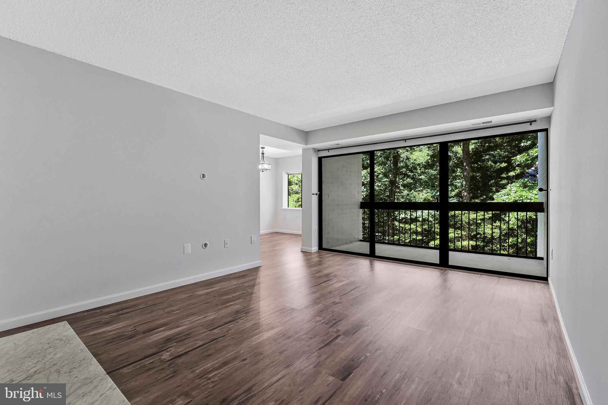 Move in with confidence and enjoy peace of mind in this updated first-floor, 2-bedroom, 2-bath garden-style condo in Reston’s Springwood community. Nestled among the wooded treetops, this home offers privacy, comfort, and low-maintenance living with updates buyers value most.

The extended foyer opens to a spacious living room featuring a cozy wood-burning fireplace and oversized sliding glass doors leading to a private patio. The dining area flows into the kitchen with ample workspace and room for a breakfast table.

The flexible layout includes a spacious secondary bedroom, full hall bath, large laundry/utility room, and a primary suite with walk-in closet and updated en-suite bath.

Major improvements include fresh paint throughout, updated primary bath shower and flooring, new stackable washer and dryer (2026), stainless steel dishwasher (2025), hot water heater (2023), electrical panel (2022), and luxury vinyl flooring throughout (2022).

Includes one reserved parking space (#75) plus additional resident and guest parking. Enjoy Reston Association amenities including pools, tennis and pickleball courts, lakes, playgrounds, and 55+ miles of trails—all minutes from South Lakes Shopping Center, Reston Town Center, Metro, major commuter routes, and Dulles Airport.